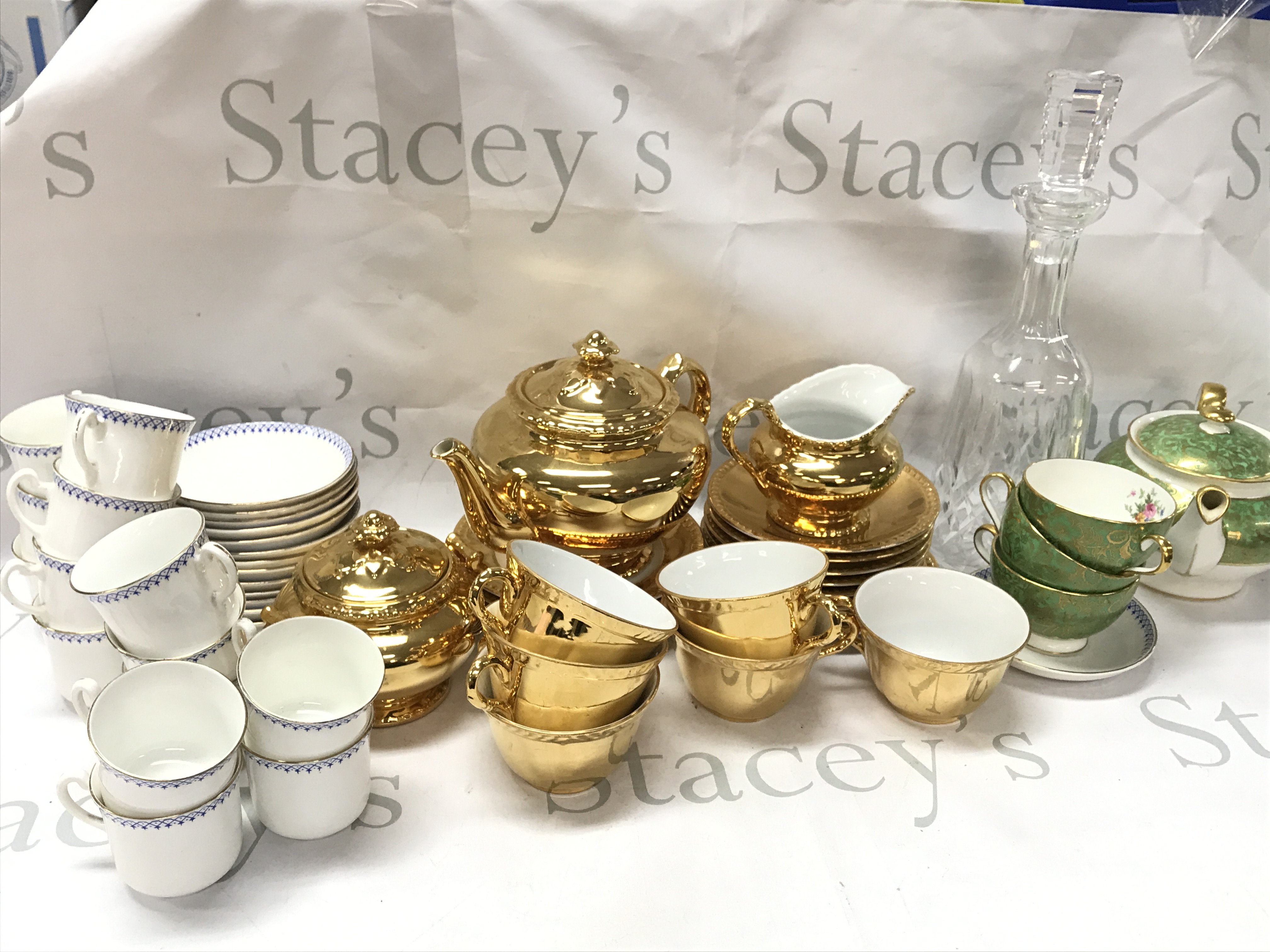 Royal Worcester gold tea set including Tea jug, Cups, Saucers , Minton brocade , glass decanter, English bone China. This lot cannot be posted
