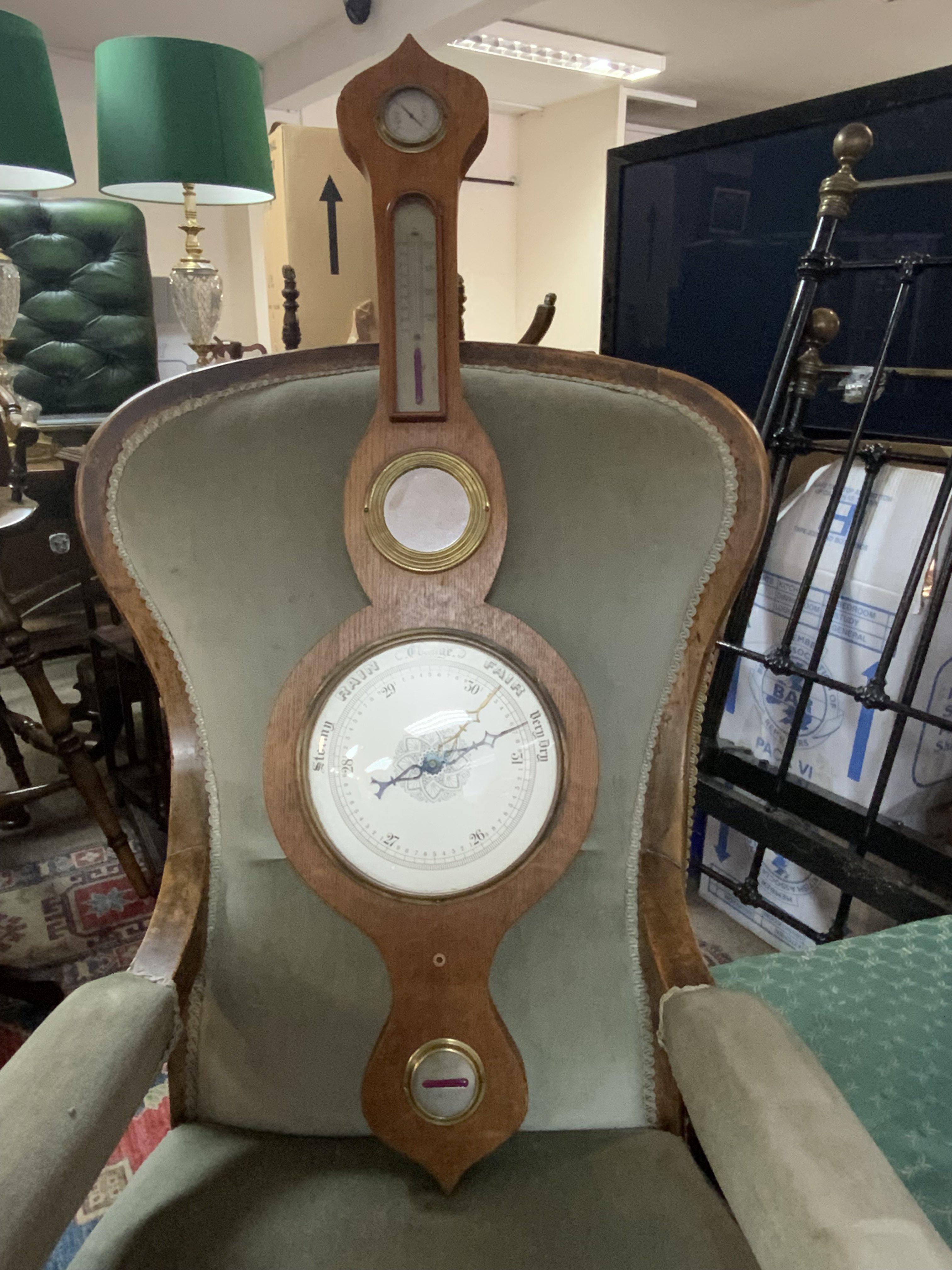 An Oak silvered dial barometer. 94cm.