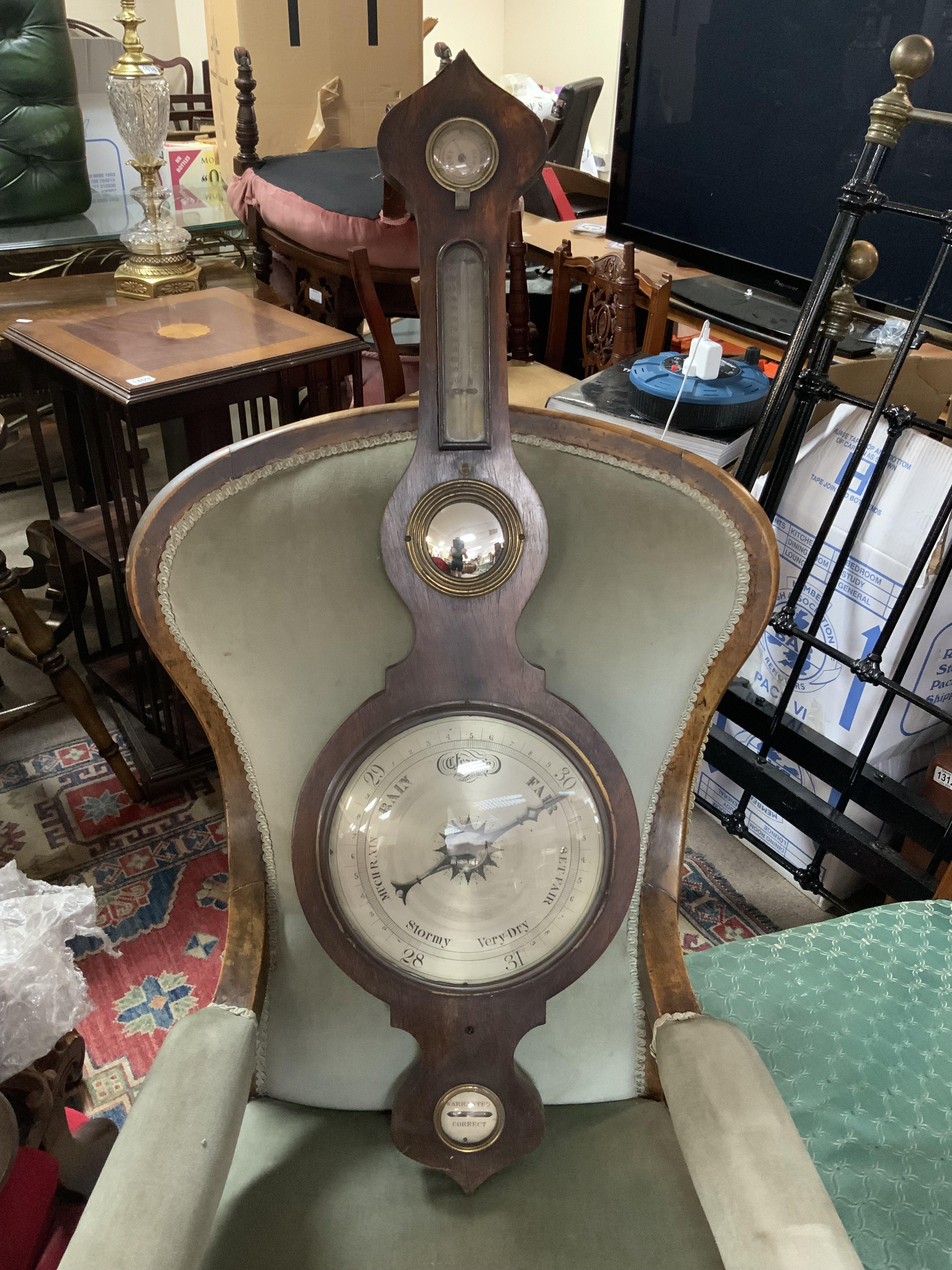 An Antique a Wheel barometer with silvered dial. 103cm.