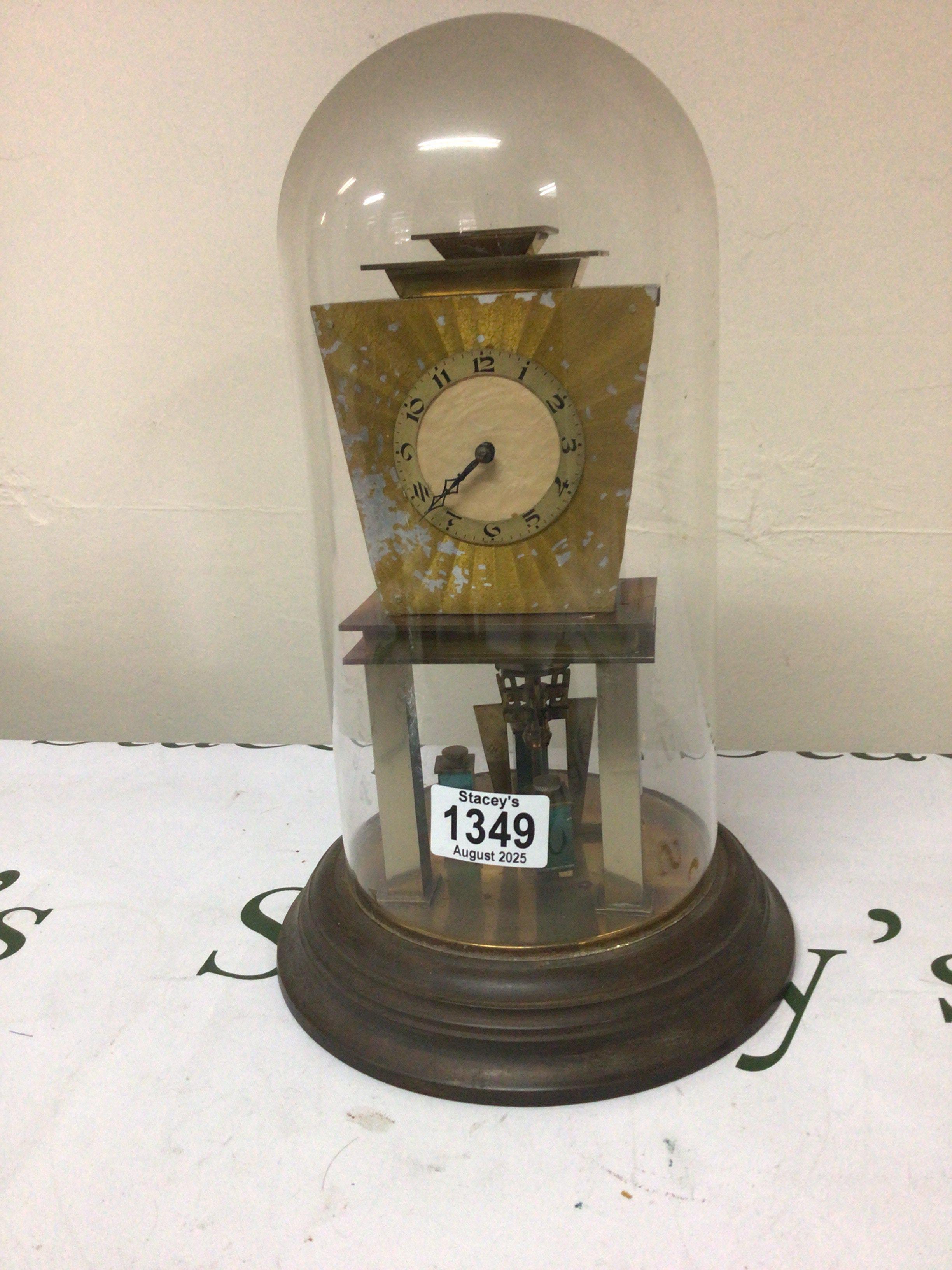 An Art Deco German Anniversary clock under a glass dome with metal pillars dome no damage clock for restoration.Height 32cm.