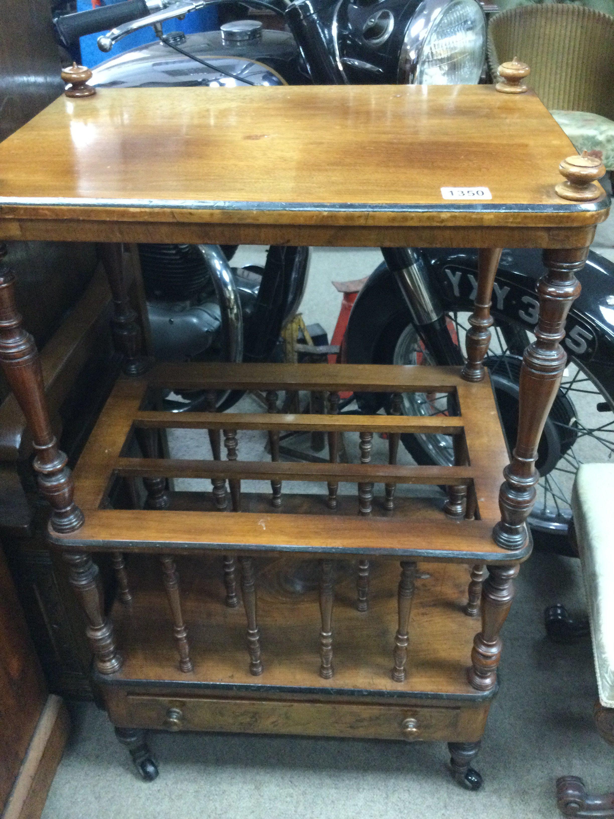 A Victorian walnut Canterbury with three open sections fitted with a single Drawer .
