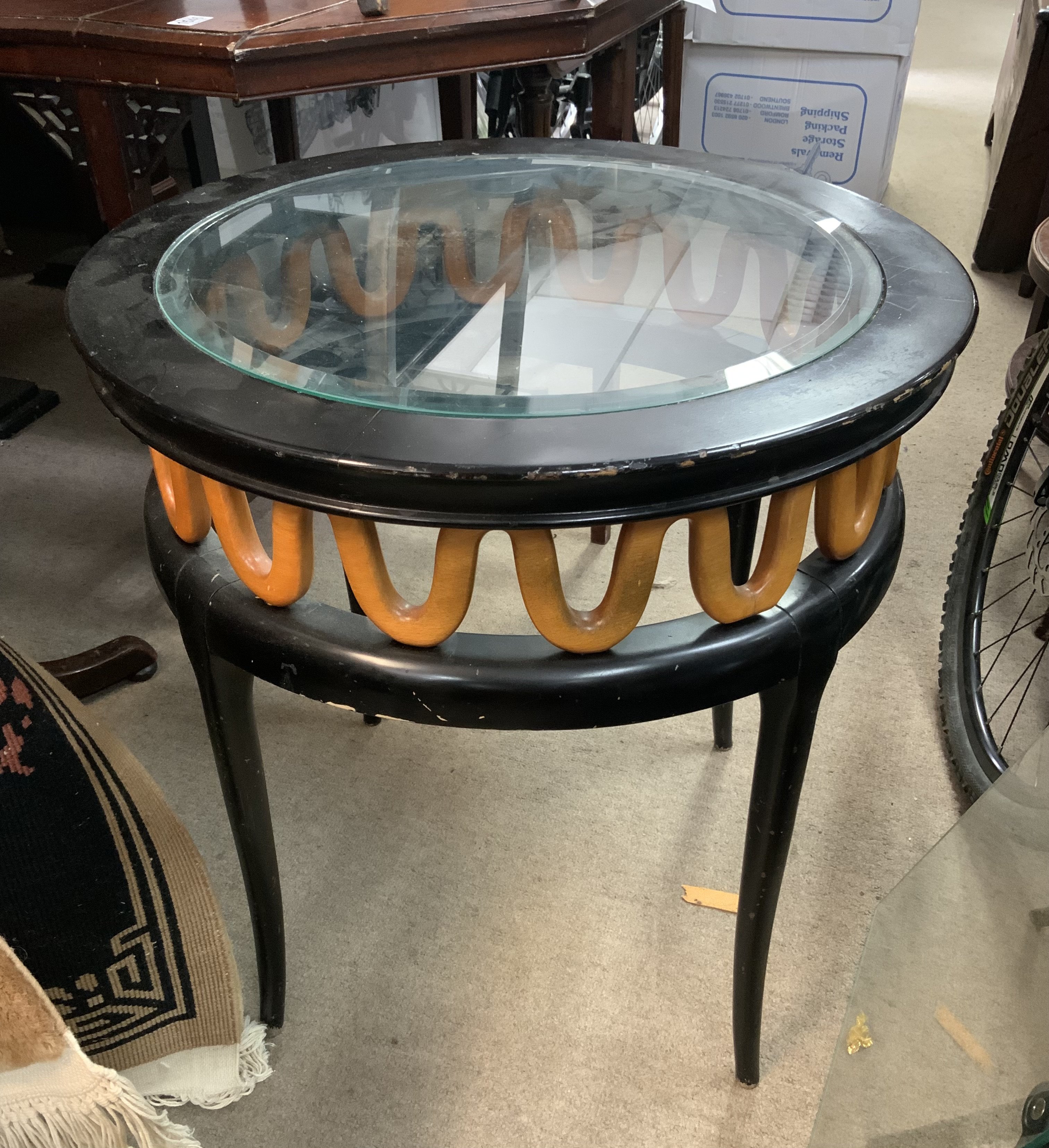 A small ebonized glass topped coffee table. 59cm x 61cm