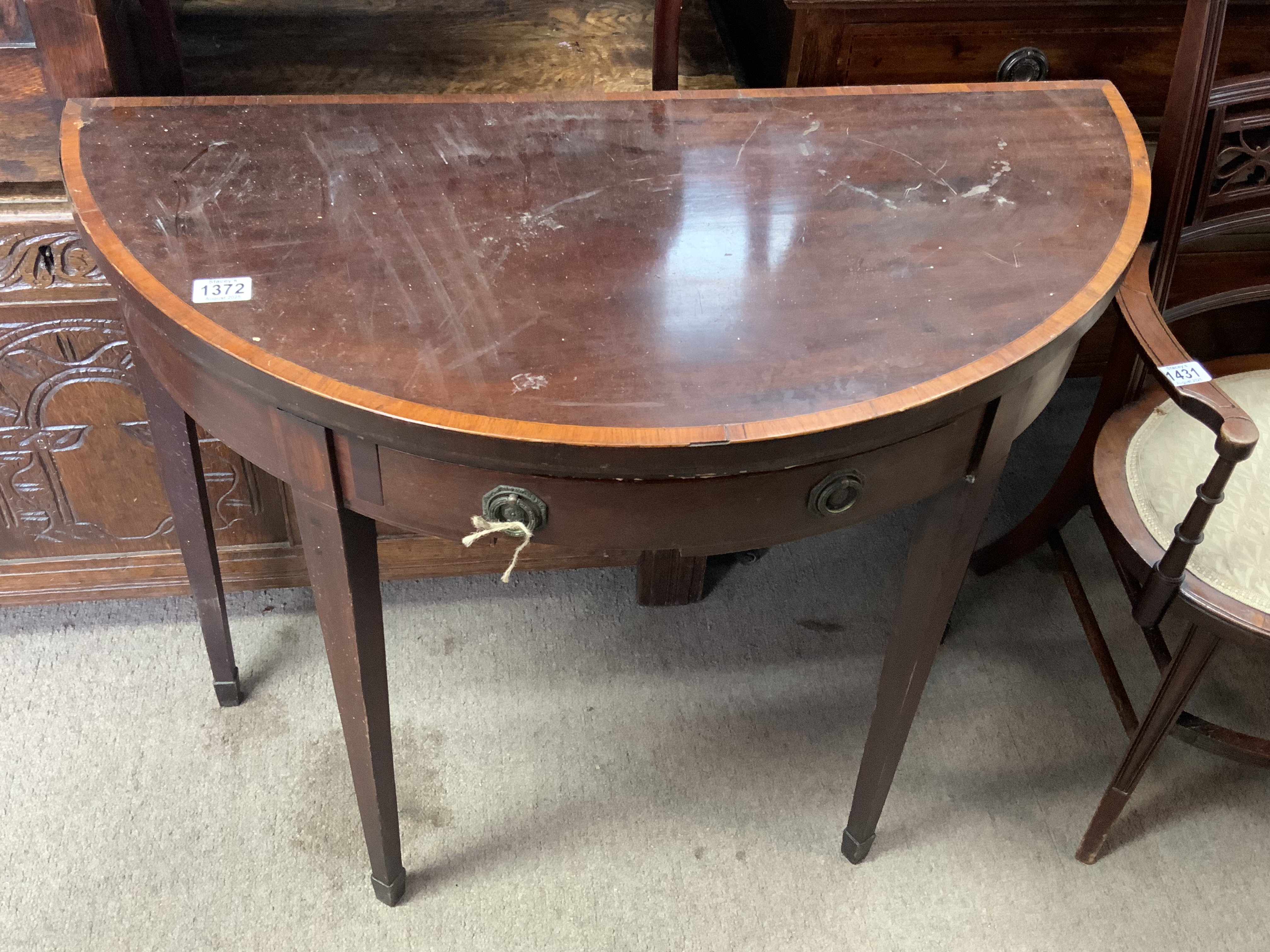 A Georgian demi lune folding table. 91cm x 74cm