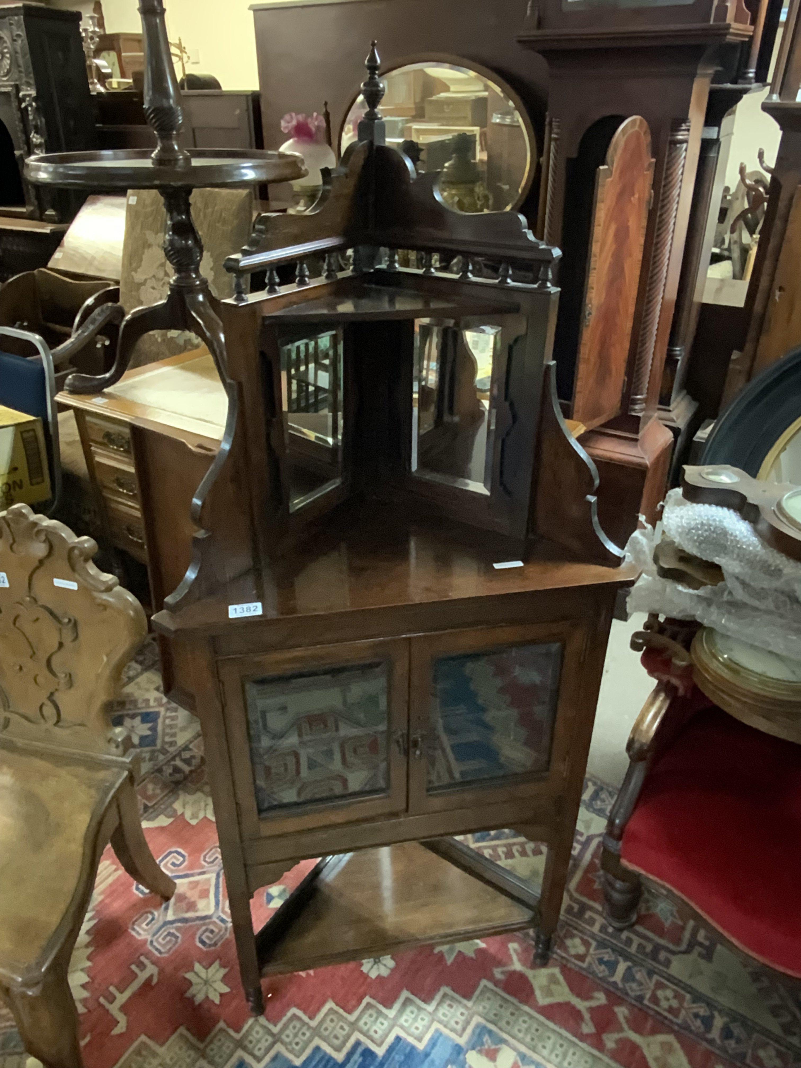 A small Rosewood veneered and mirror backed corner cabinet.. 147cm x 63cm