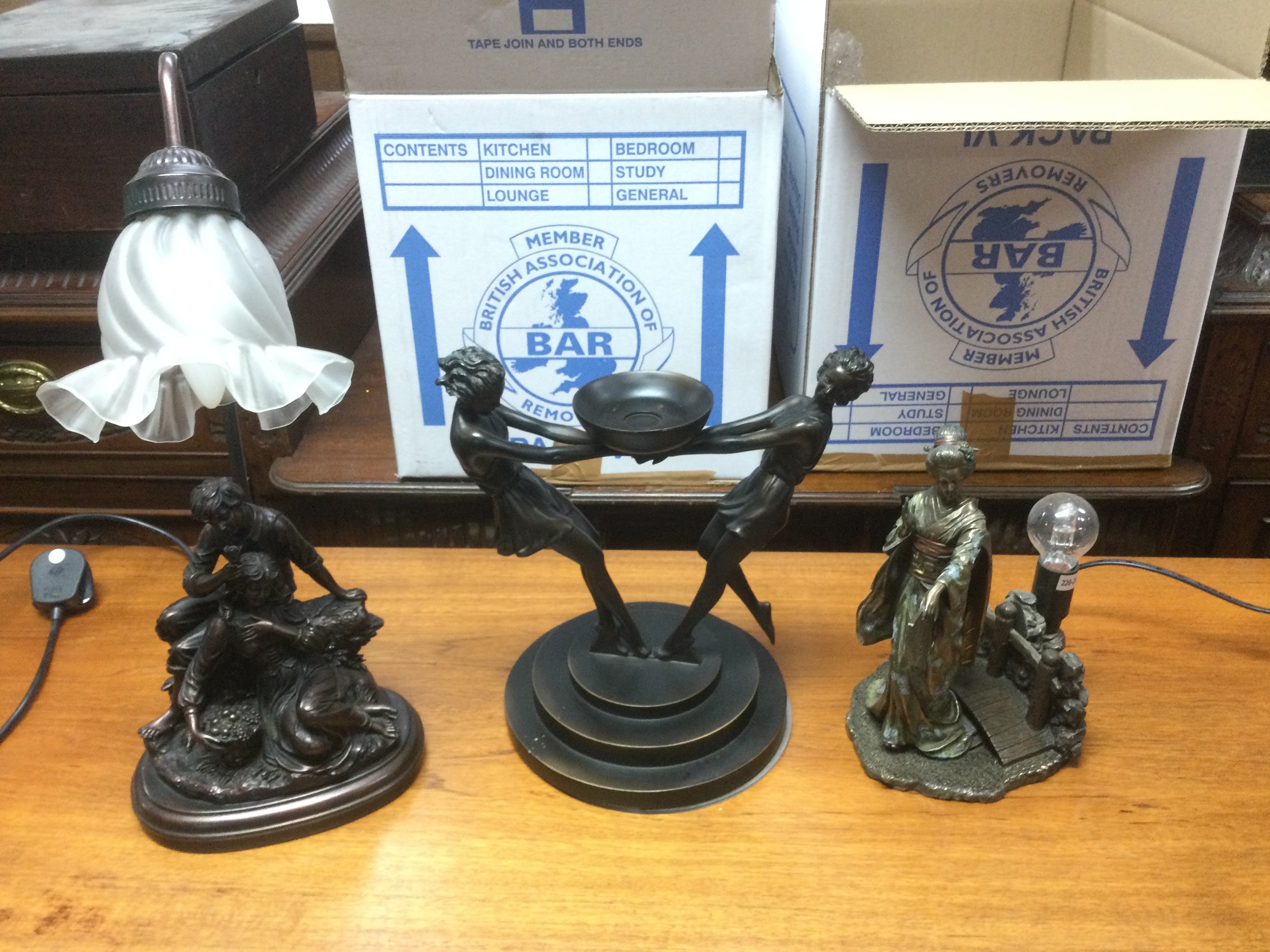 Two modern table lamps and a figural centrepiece of Classical form, largest approx 46cm in height. Shipping category D.