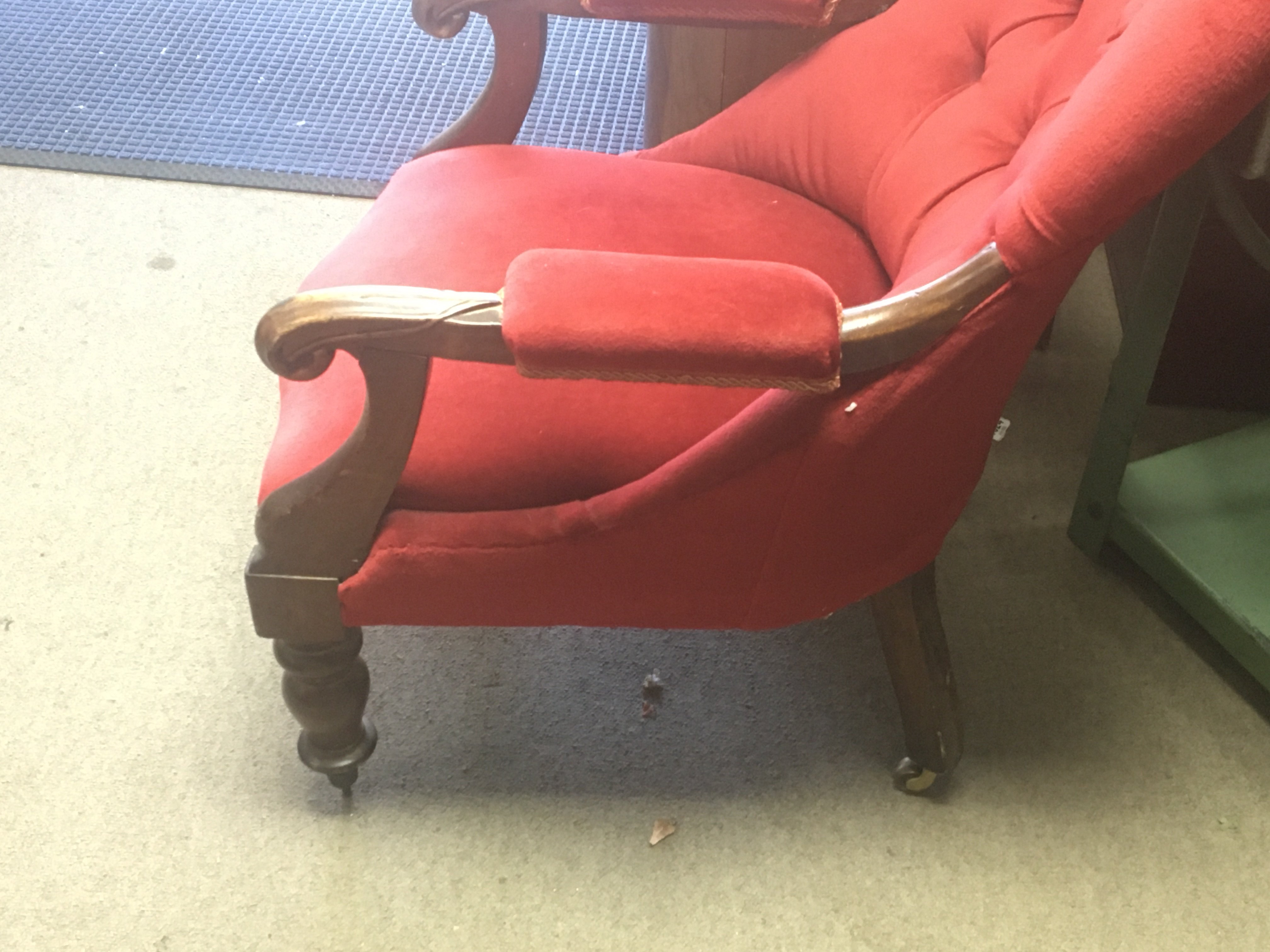 A Victorian open armchair with red upholstery.- NO RESERVE