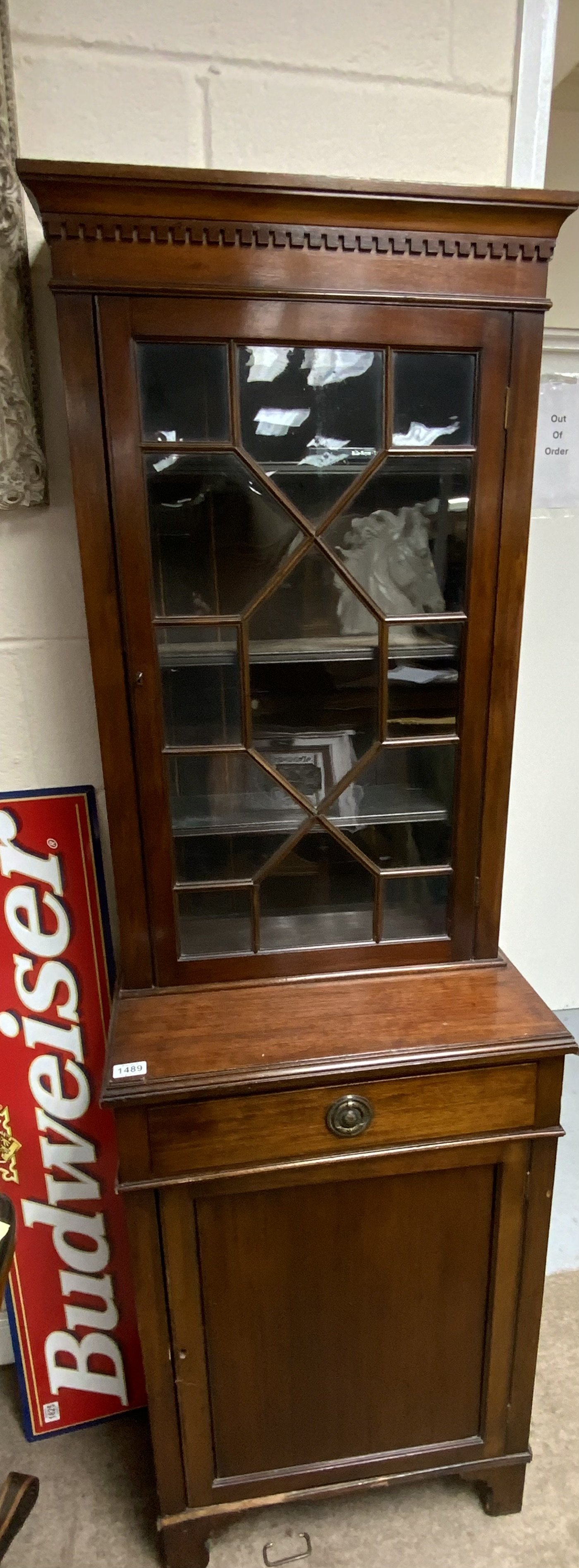 A small mahogany cabinet the top with a glazed door above a drawer and cupboard. 60cm wide height 189cm