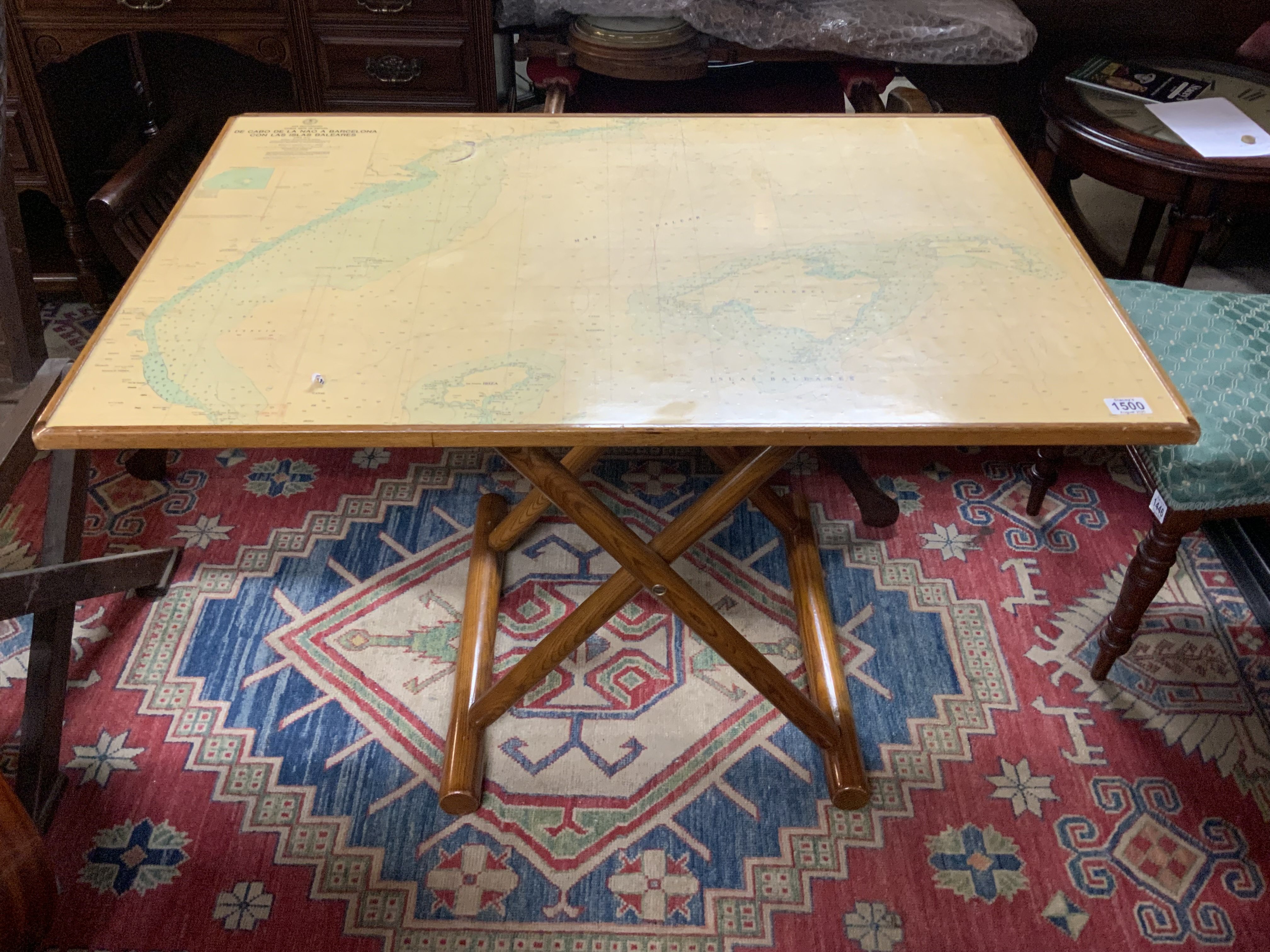 A Folding ships table inset with a map of the Balearic Islands, 105cm x 73cm adjustable height.