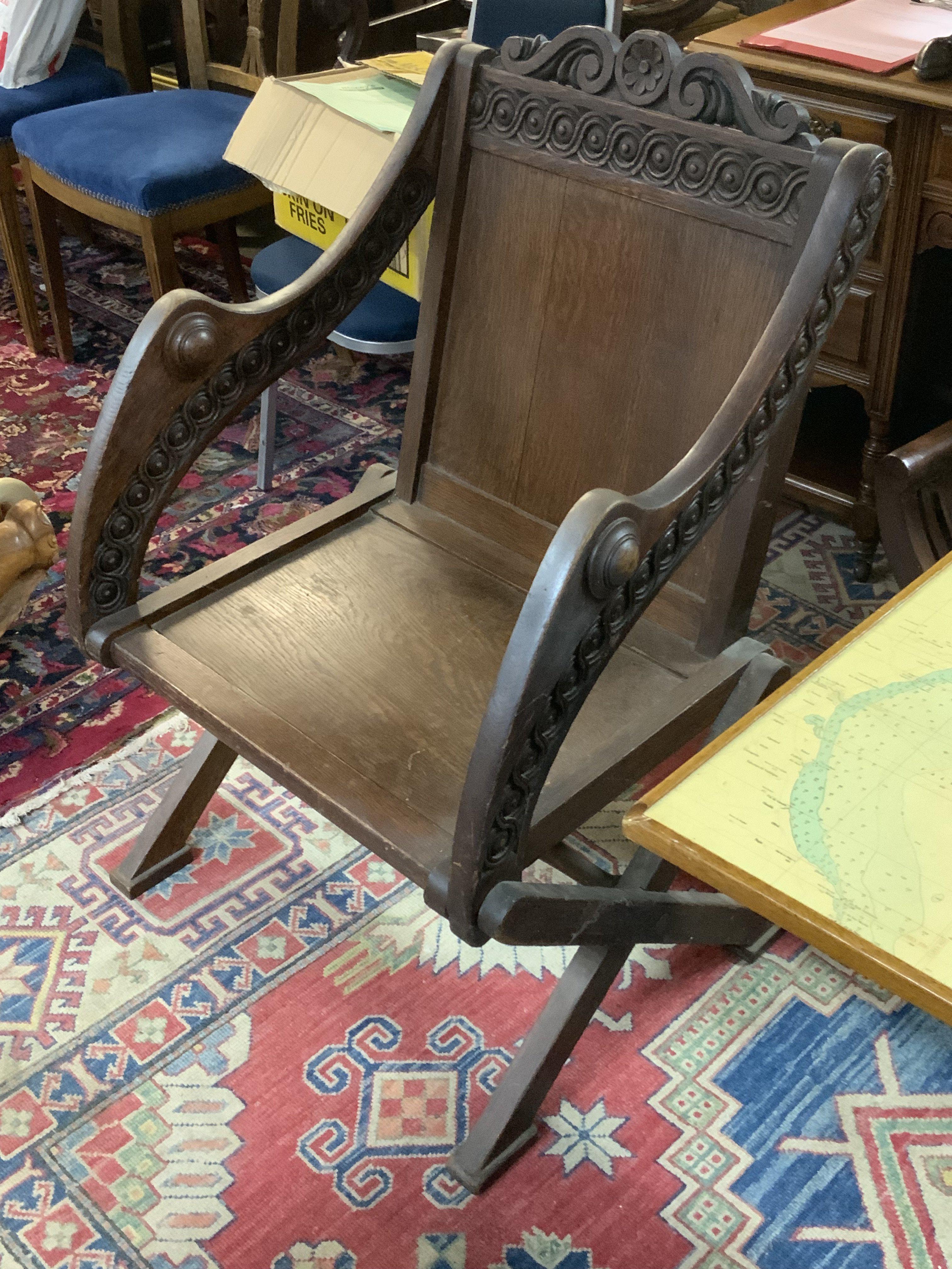 An Antique carved oak Glastonbury chair.