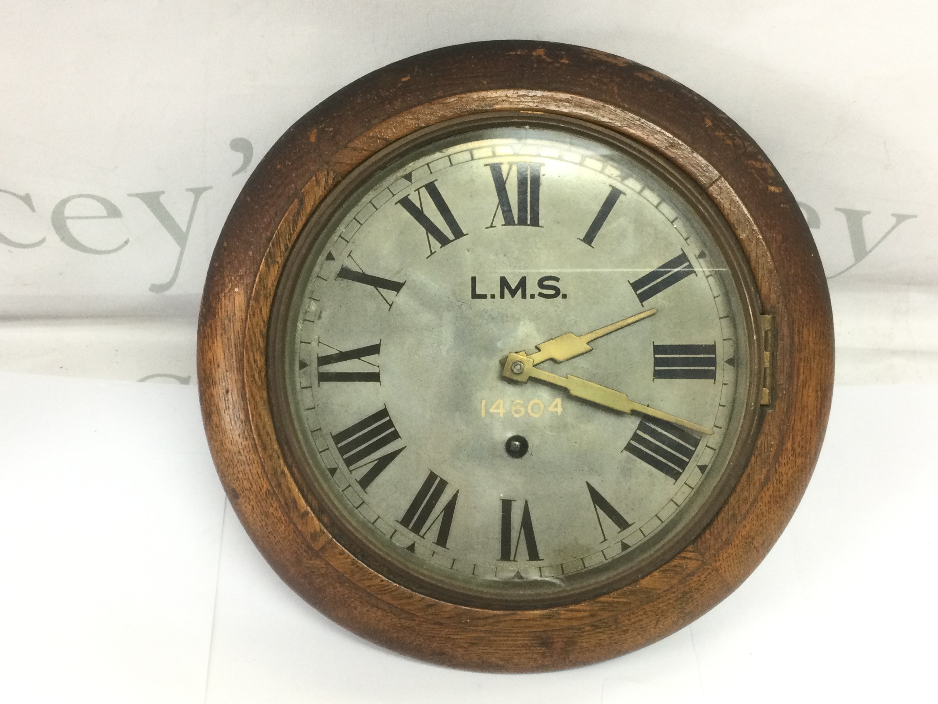 An LMS wall clock, approx diameter 28cm. Shipping category D.