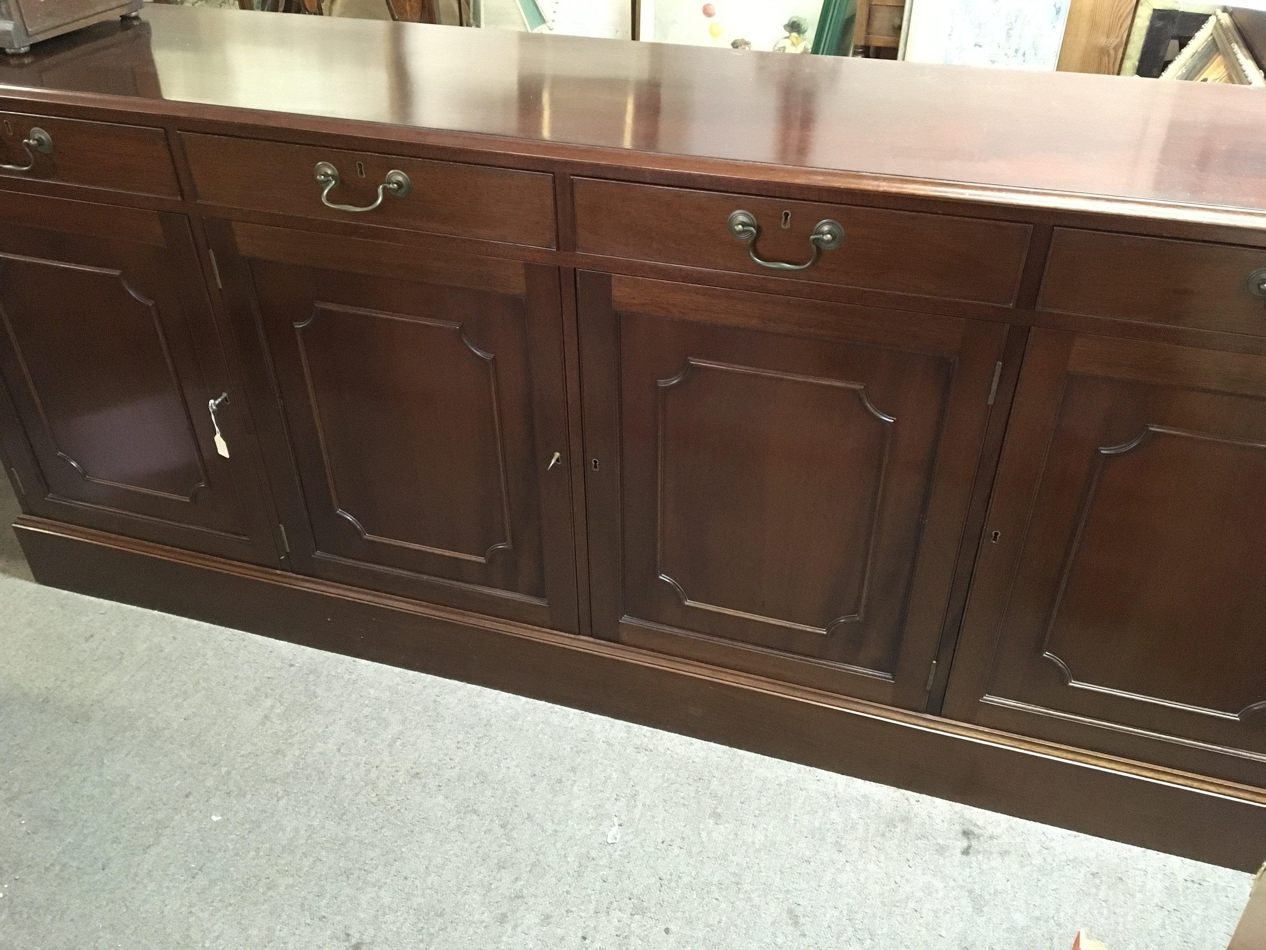 A Quality Mahogany sideboard Redman & Hall fitted with drawers and cupboards our oak lined drawers above cupboards with keys length 202cm. NO RESERVE