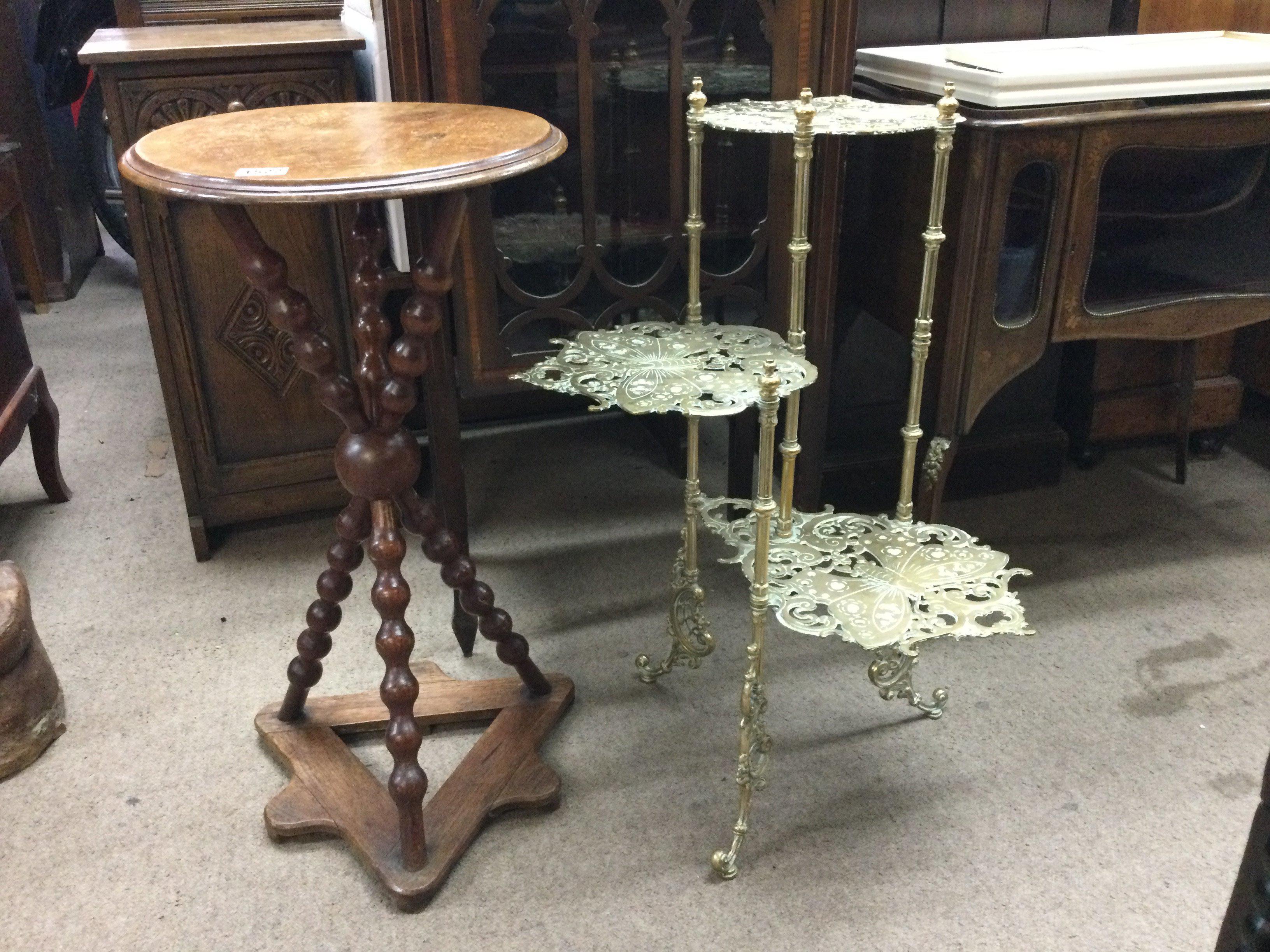 A three tier brass plant stand and a mahogany Gypsy table .