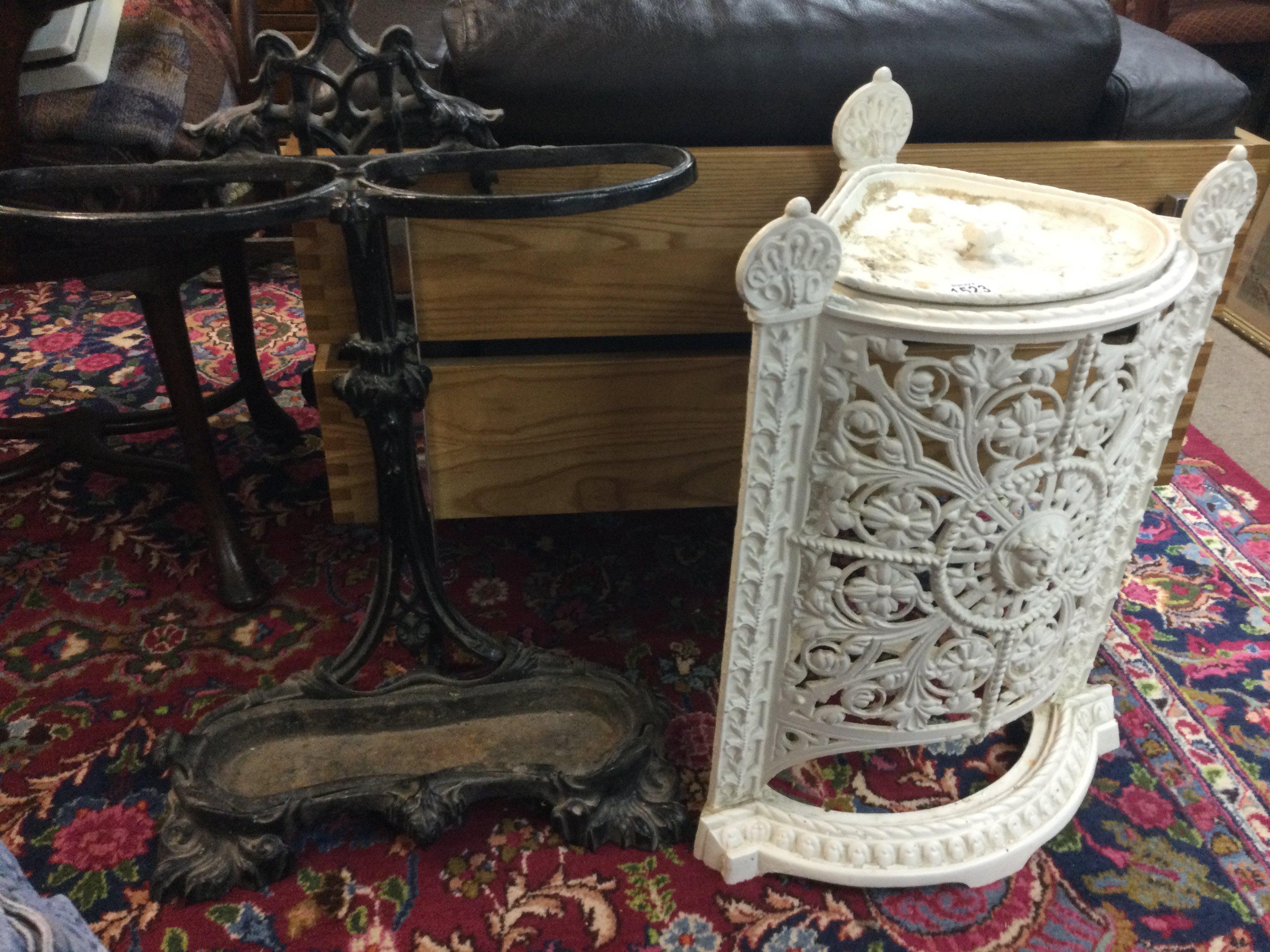 Two cast iron stick stands .