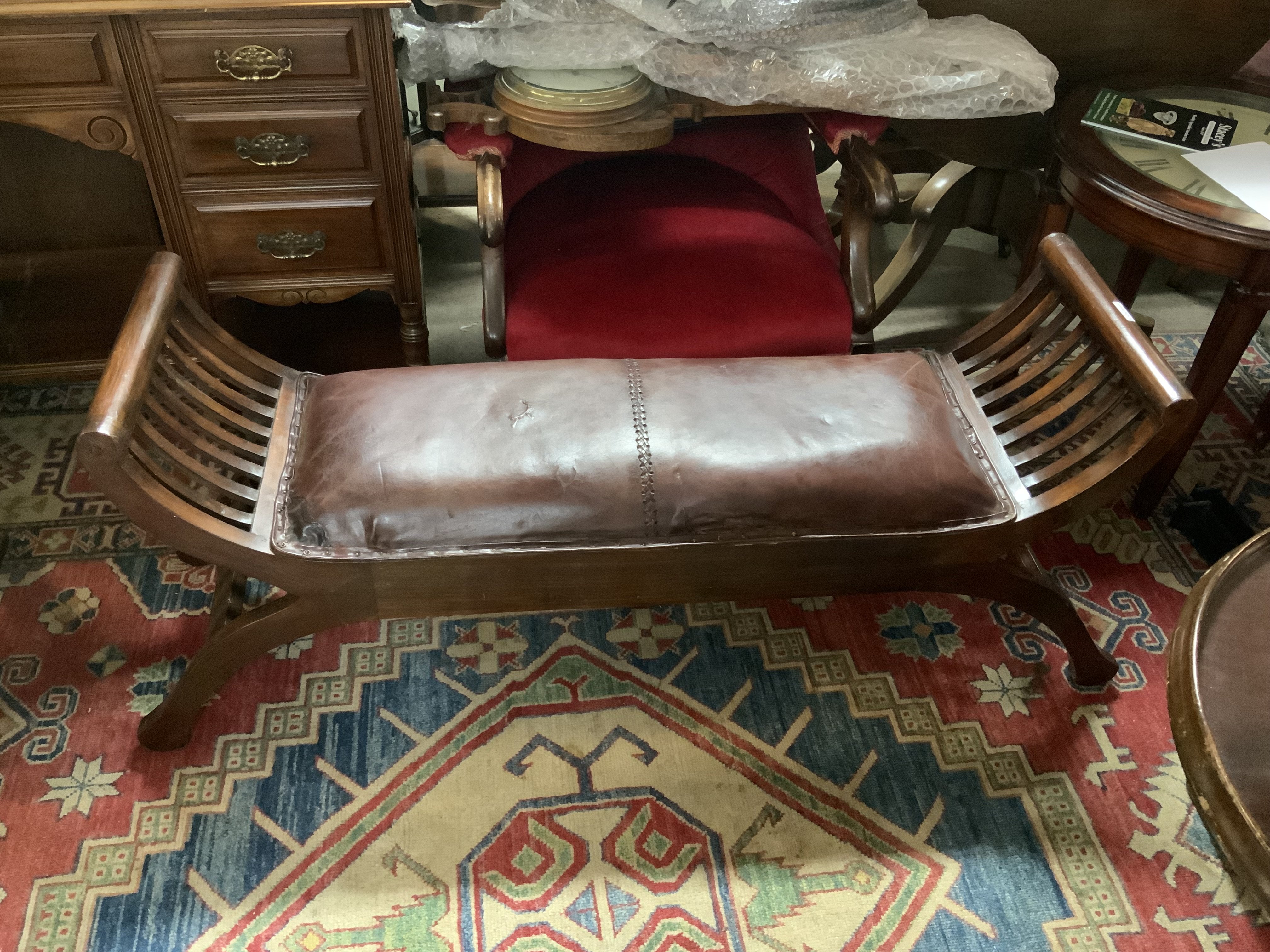 A Regency style leather upholstered window seat. 120cm x 52cm x 36cm.