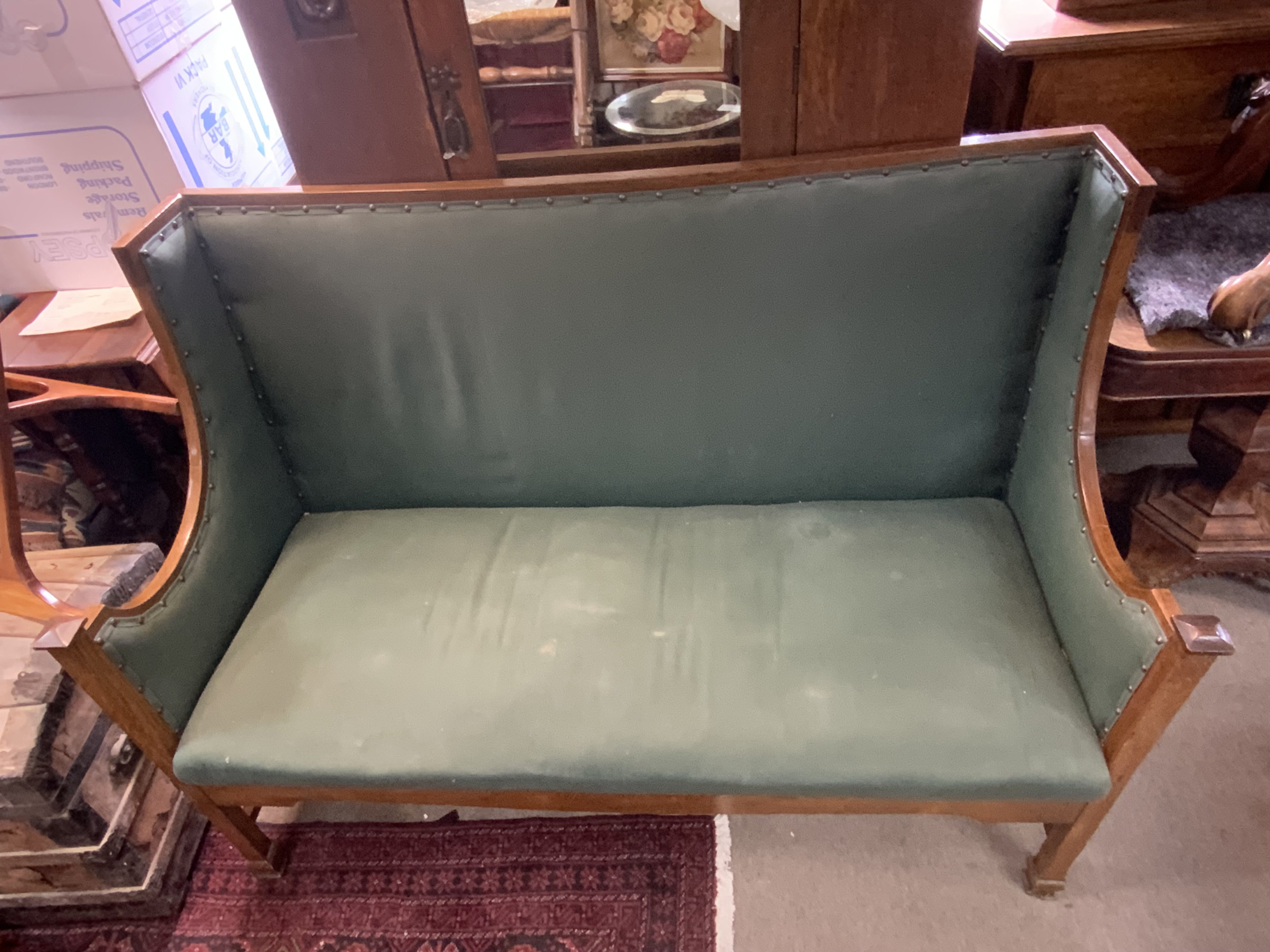 An oak framed arts and crafts upholstered settle. 139cm x 100cm x 60cm