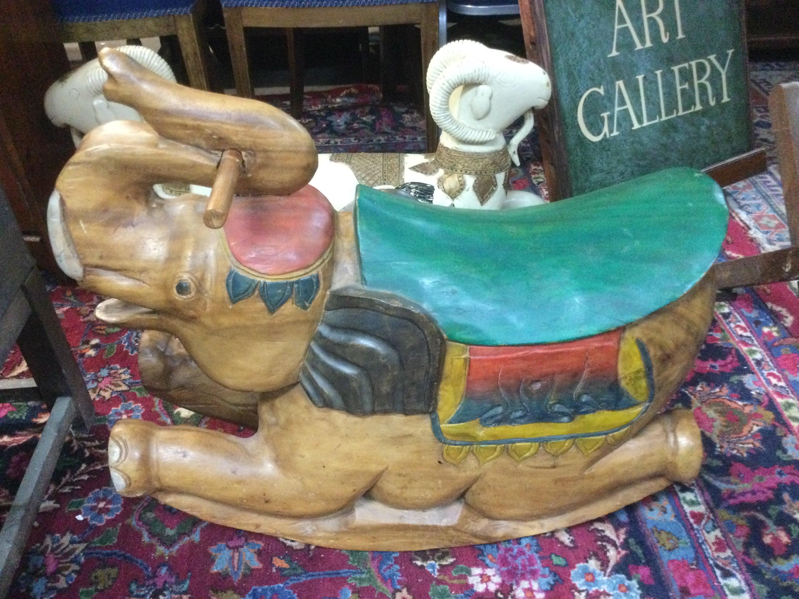 A reproduction carved wooden child's rocking horse in the form of an elephant, approx length 70cm. Shipping category D.