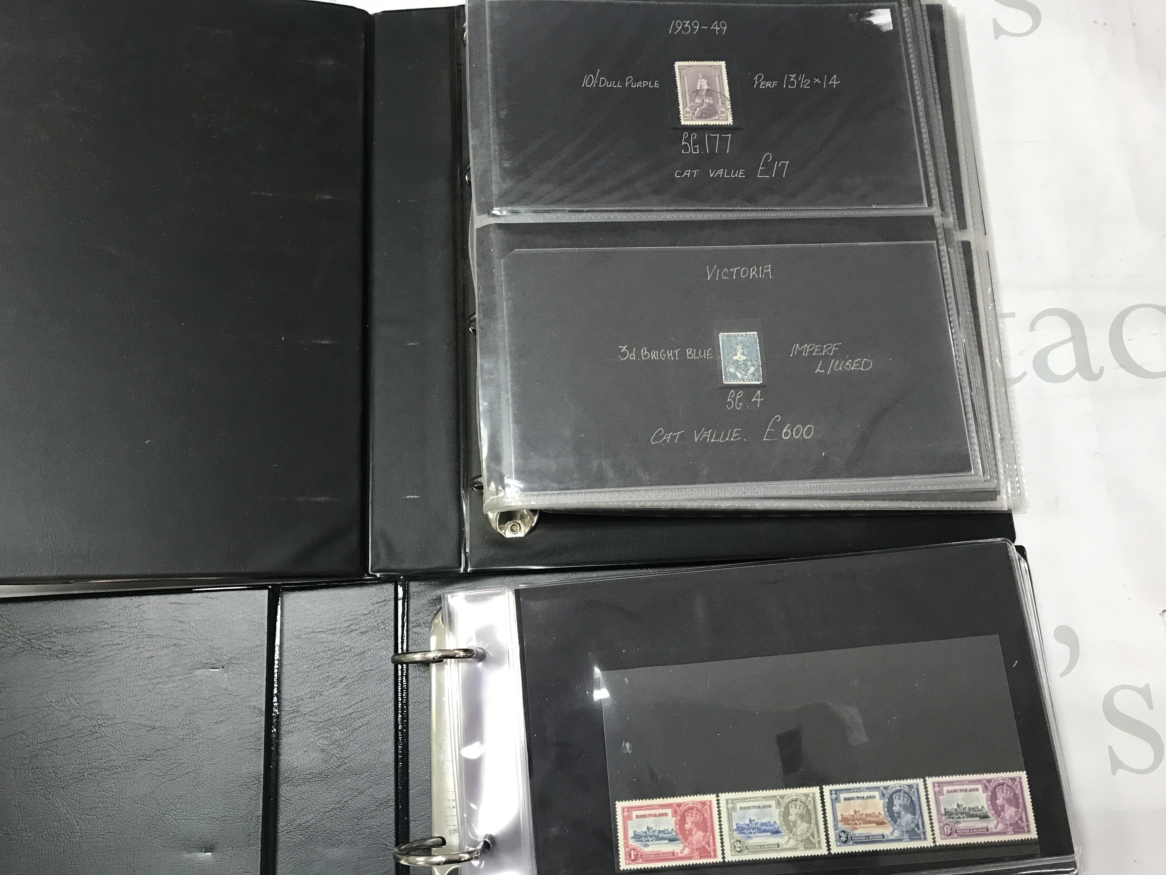 Four stamp albums containing British , Canadian and Commonwealth stamps. Mint and used. Postage category C