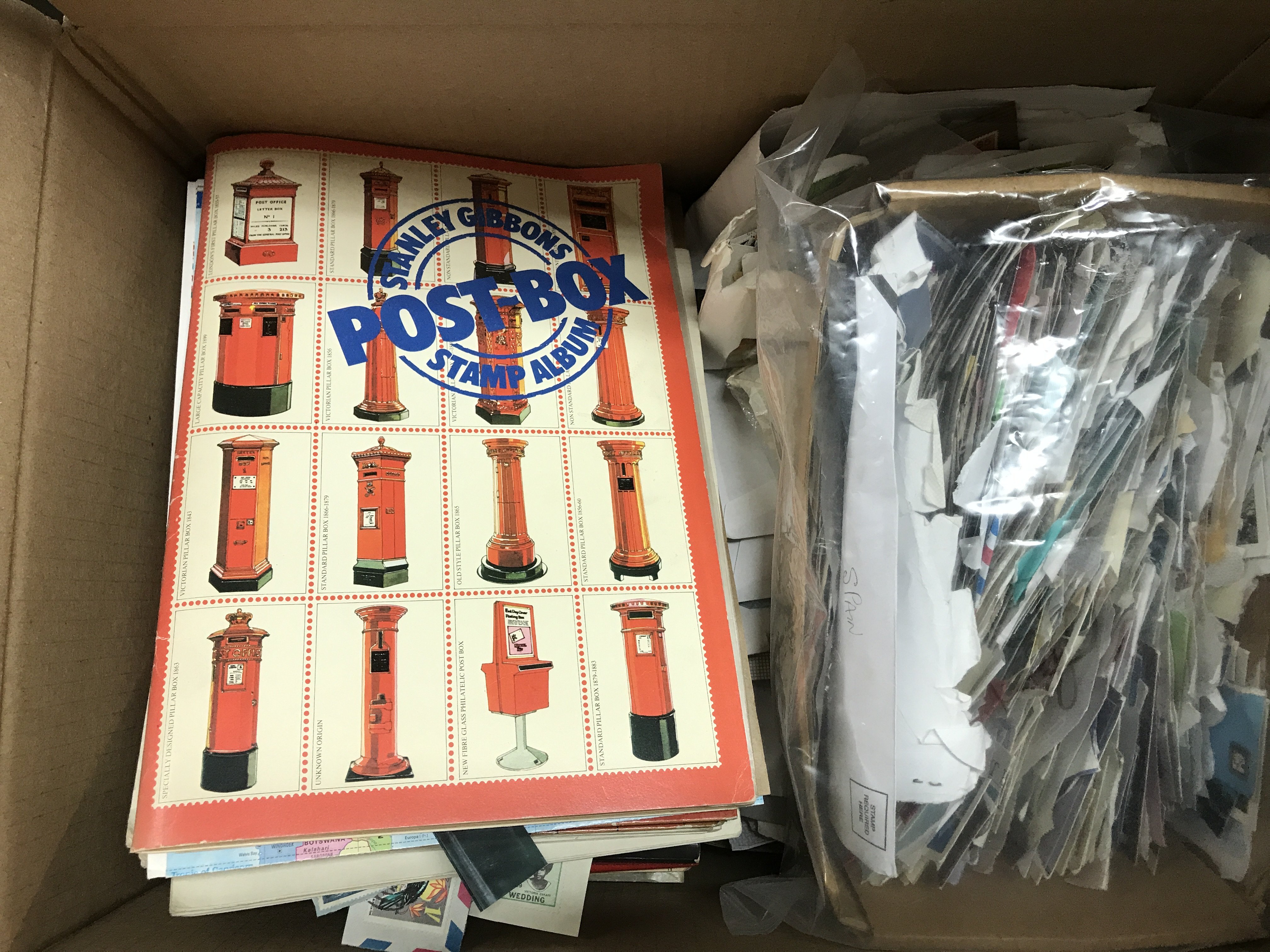 A large collection of loose world stamps and childhood albums, 3 albums of first day covers, stamp reference books etc. ( 2 boxes).