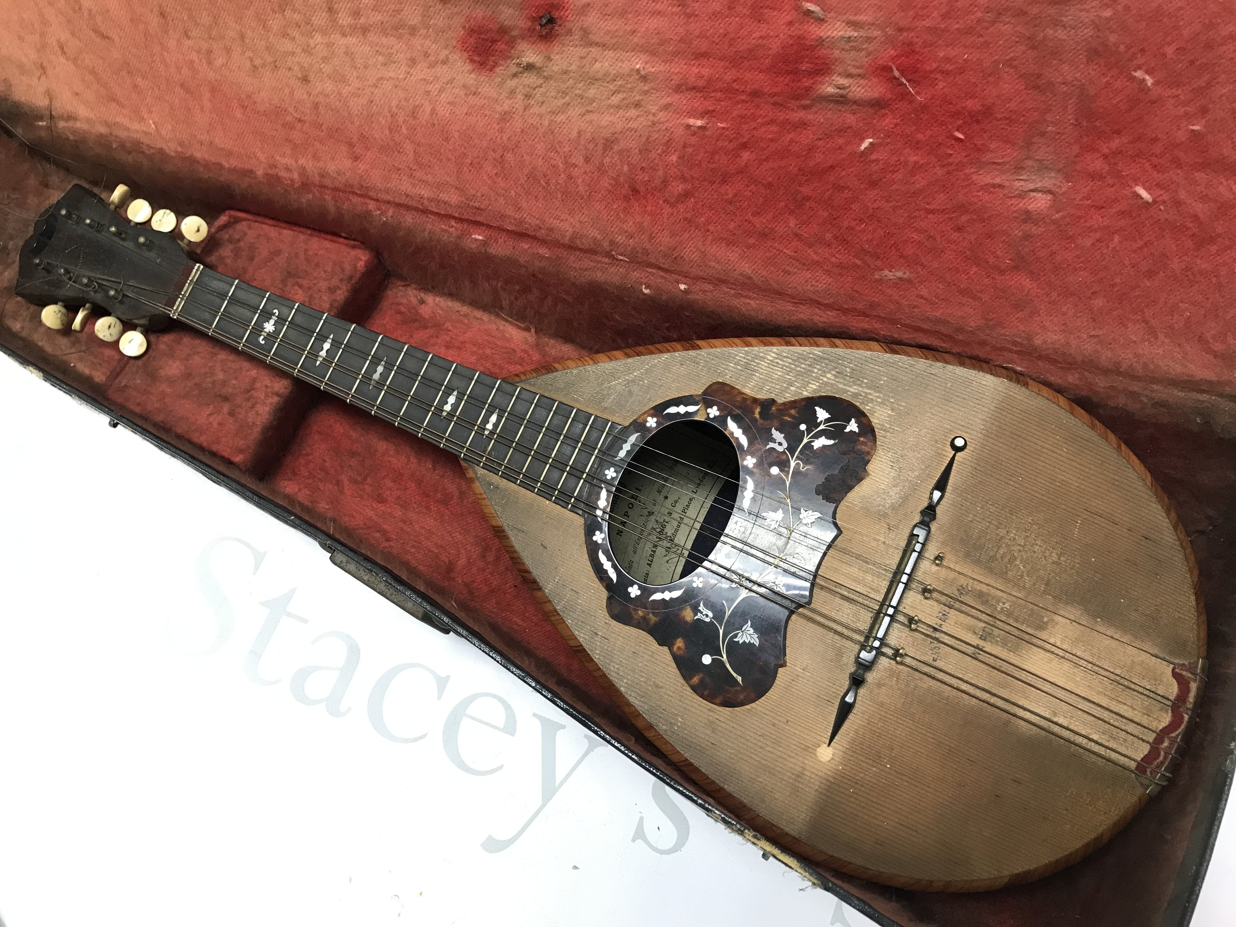 A Neapolitan Mandolin by Umberto Ceccherini, circa 1881 , 62cm long approximately. Label reads umberto ceccherini fabbrica di mandolini e mandole napoli premiate all esposizione di milano 1881 sole agents alban voigt & co 14 edmund place london. Postage category C