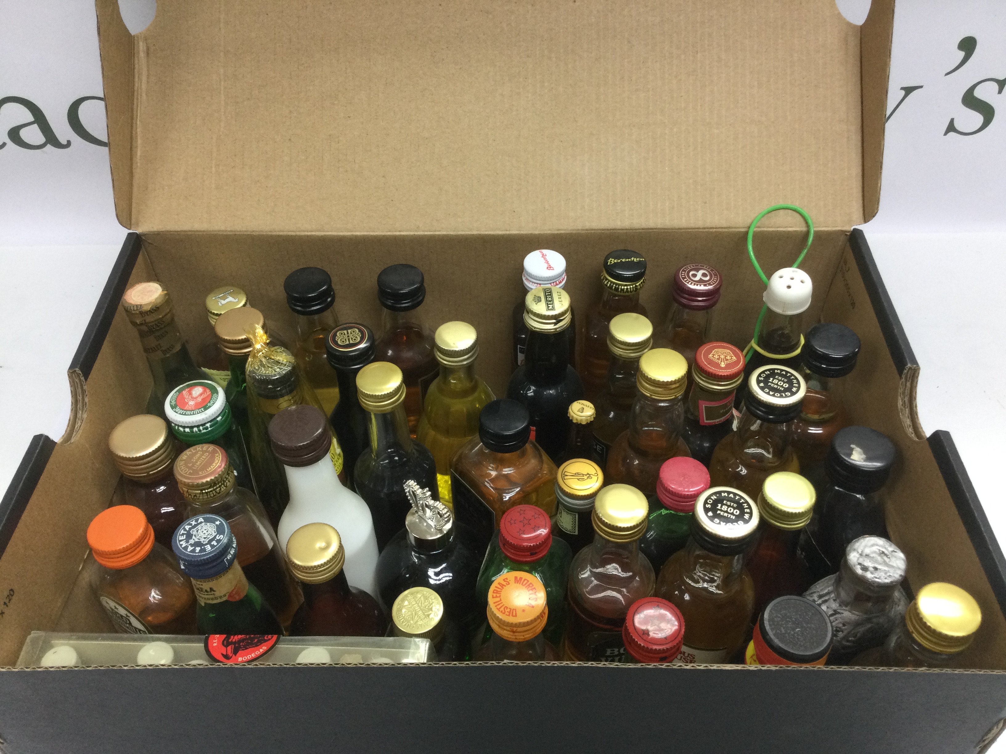 A collection of miniature bottles of alcohol. Shipping category D.