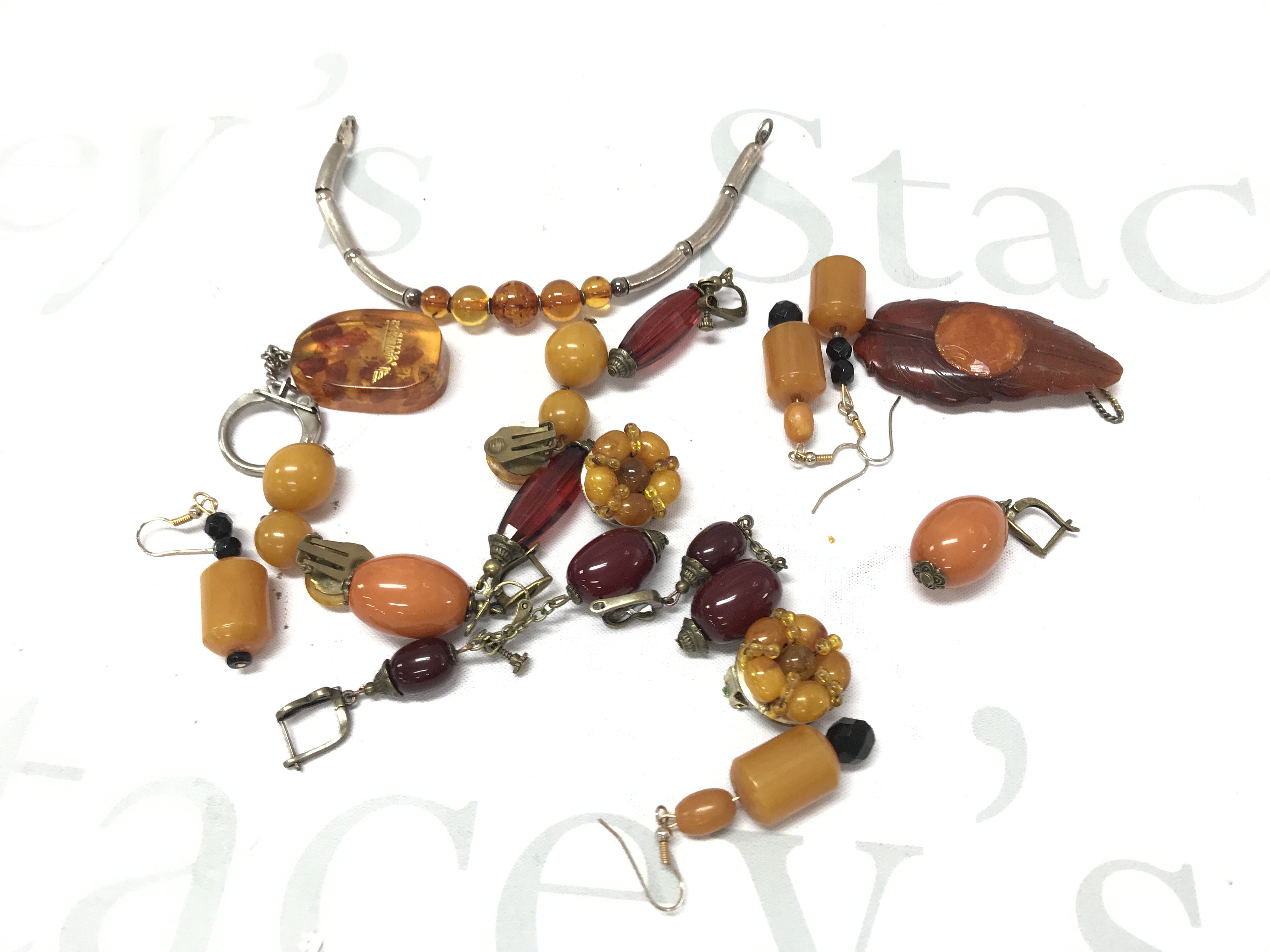 Bakelite and amber style ear clips, bracelet ,key ring , pendant etc 110g . Postage category A