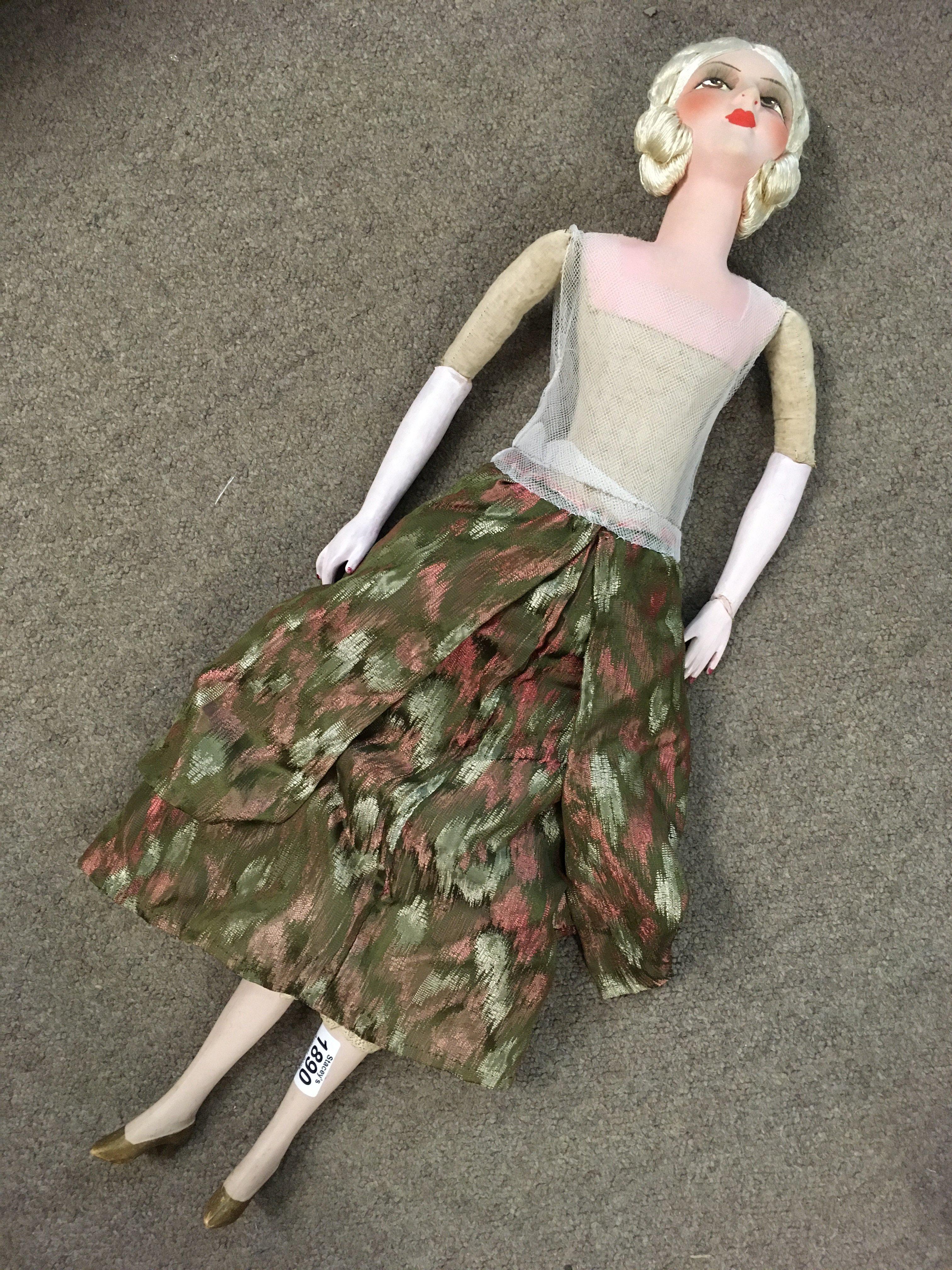 A large 1950's doll. Damage to left wrist