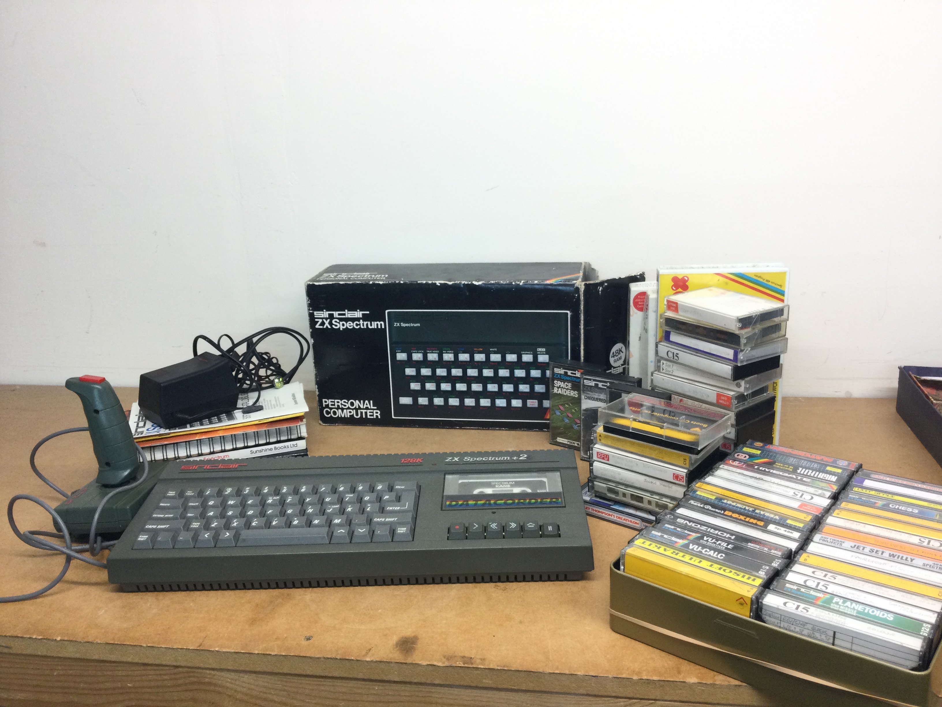 A boxed vintage Sinclair ZX spectrum PC and a Sinclair 128k ZX Spectrum +2 and games, additional games and joystick, manual . Postage category C