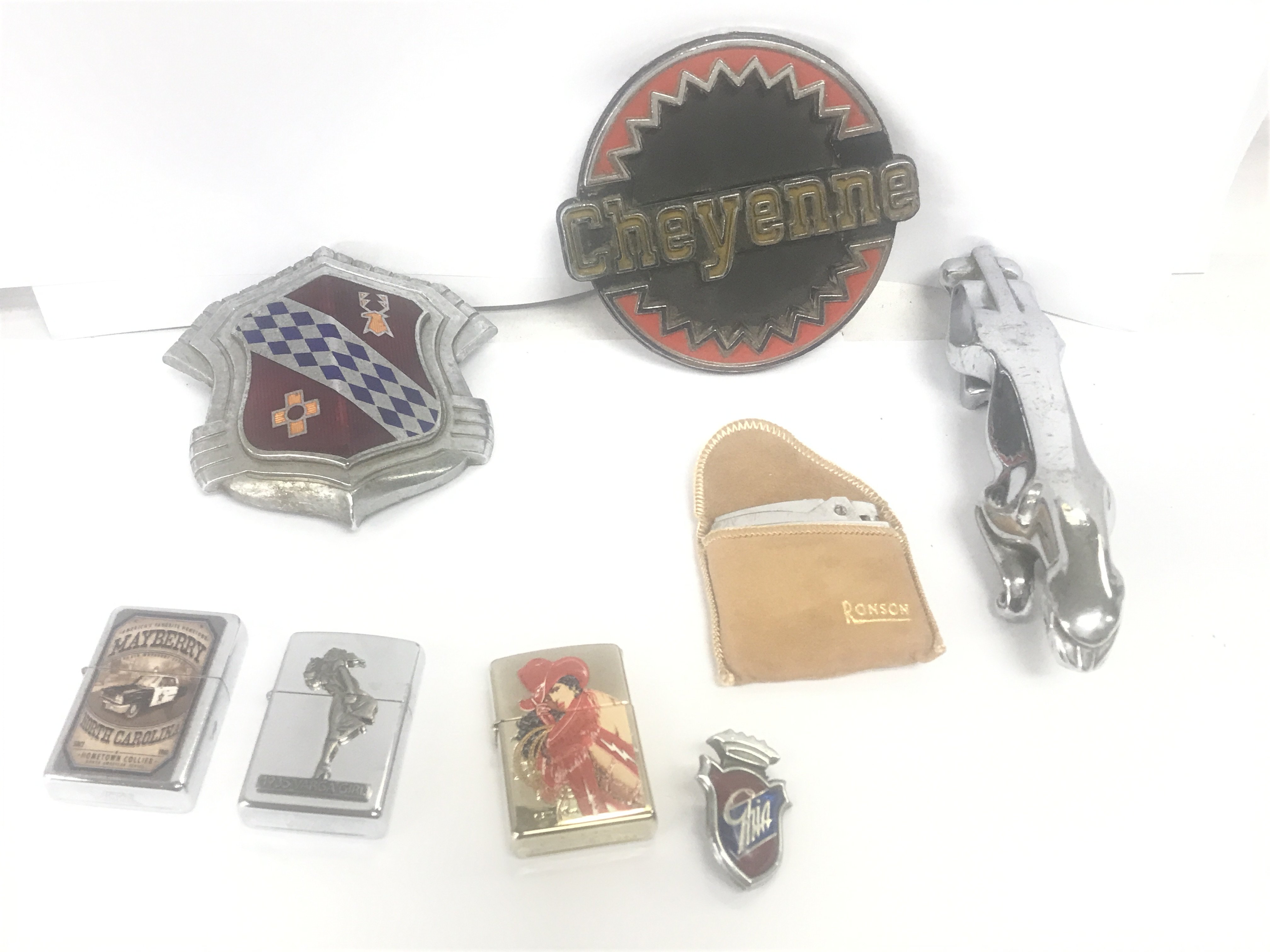 A collection of car badges and lighters - Jaguar, Cheyenne