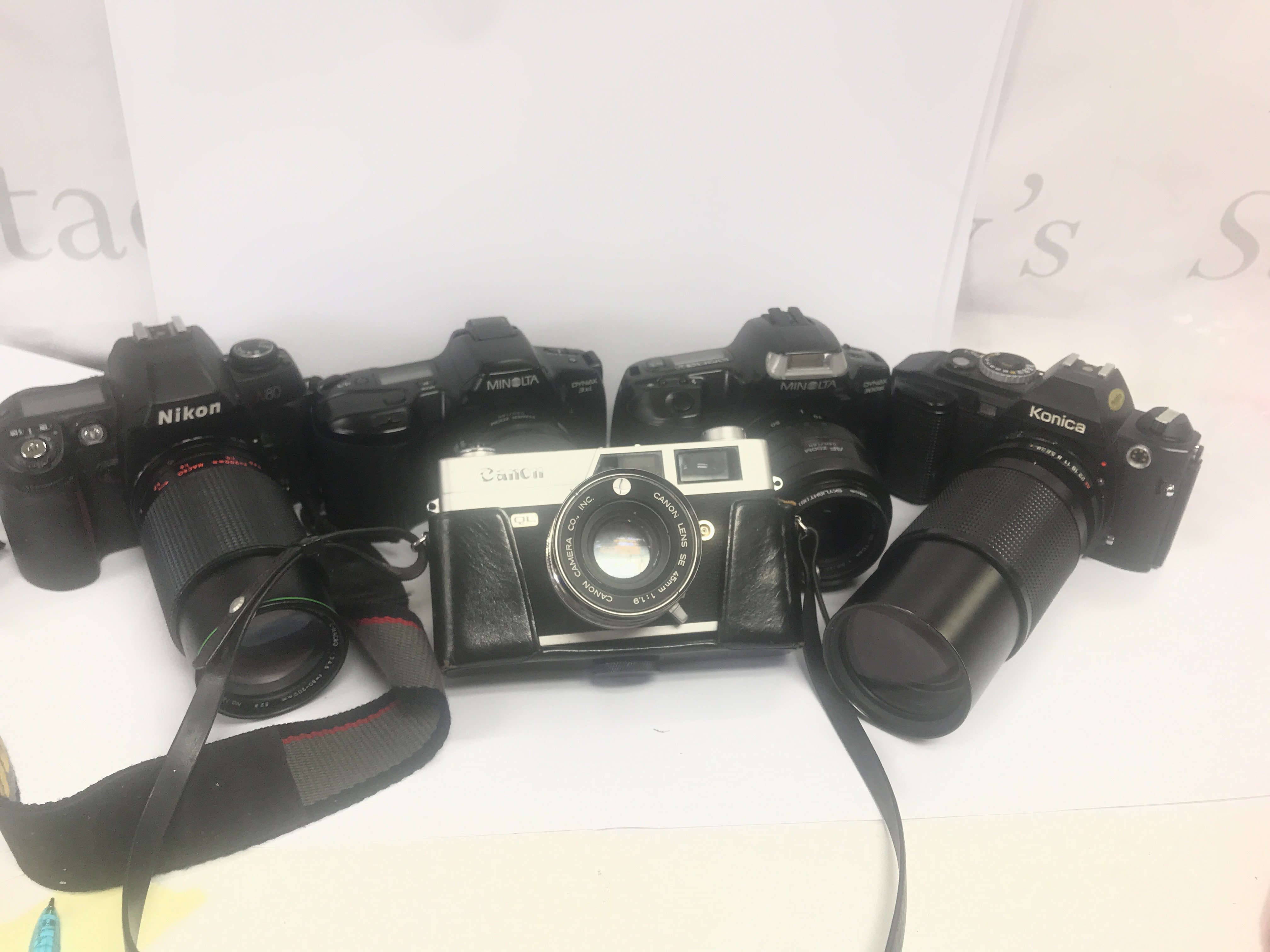 5 Vintage cameras including Nikon, Canon, Minolta, Konica