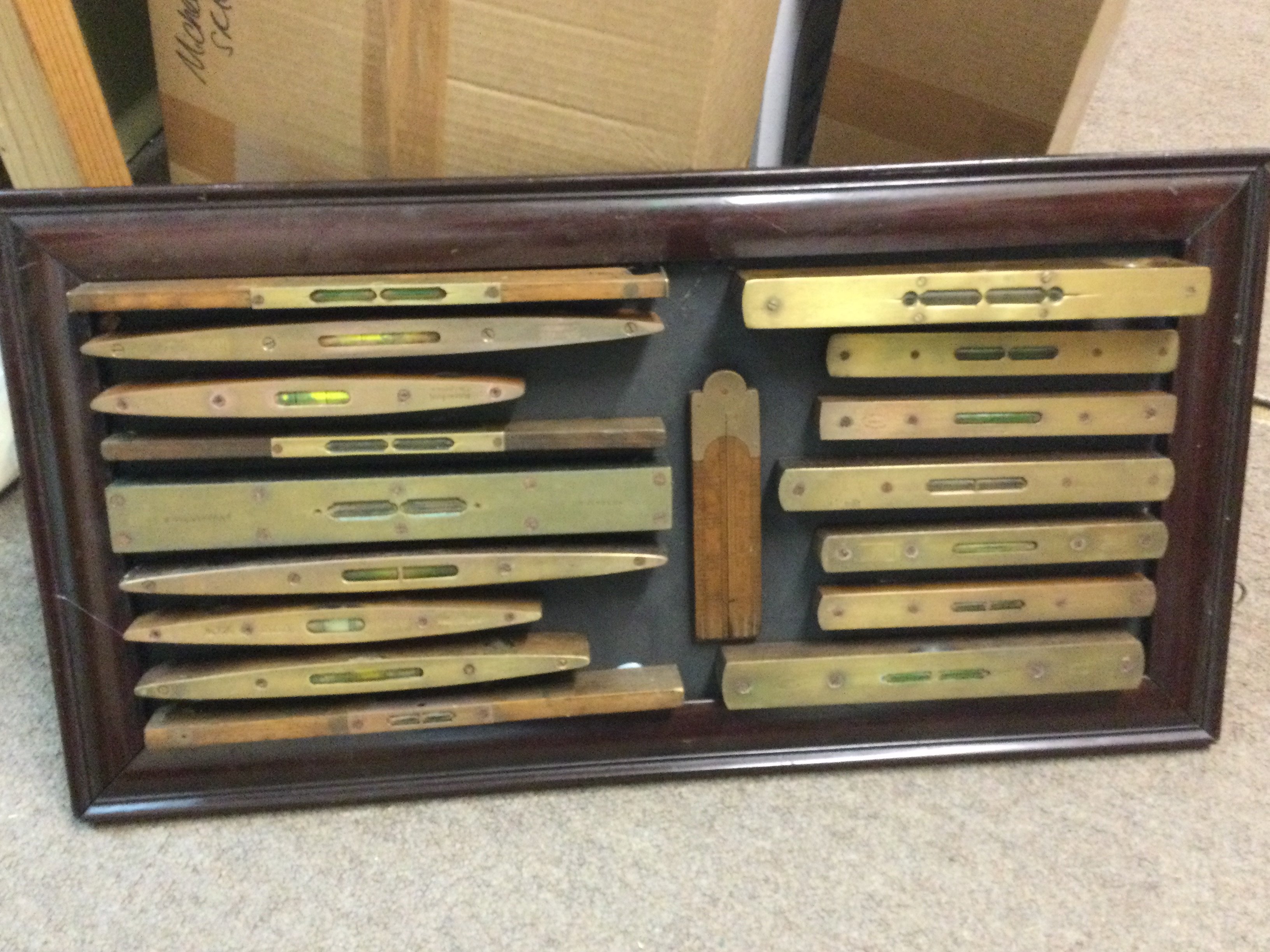 A framed display of 16 vintage spirit levels . This lot cannot be posted