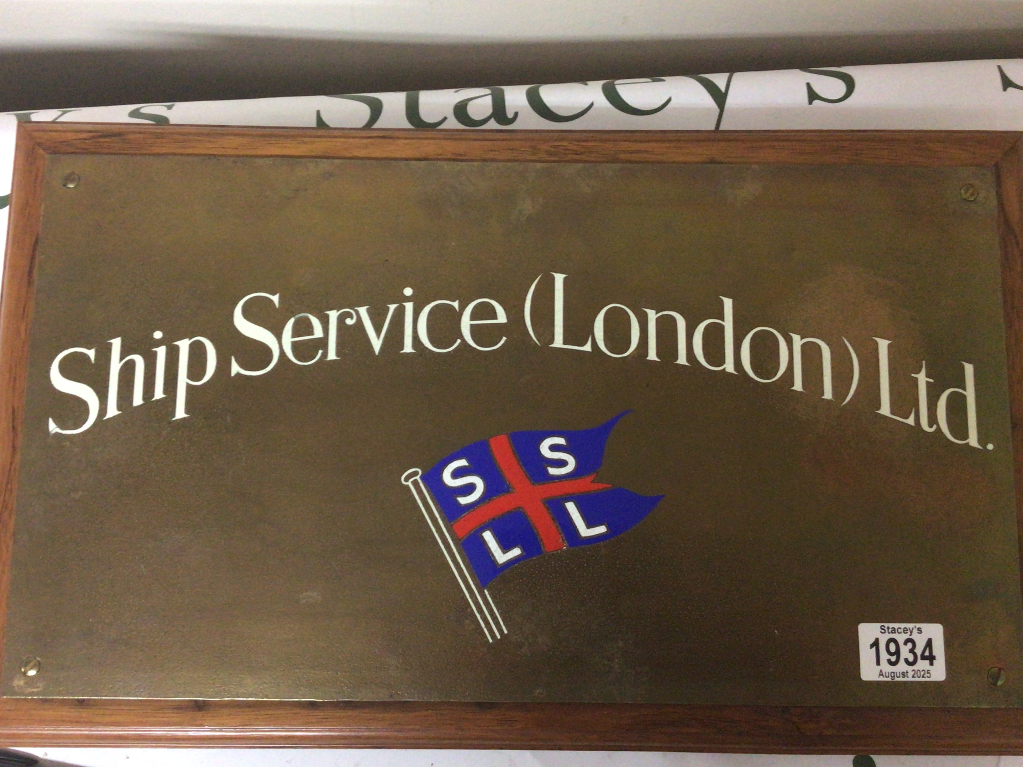An enamel decorated brass plaque Ship Service London. 25x46cm
