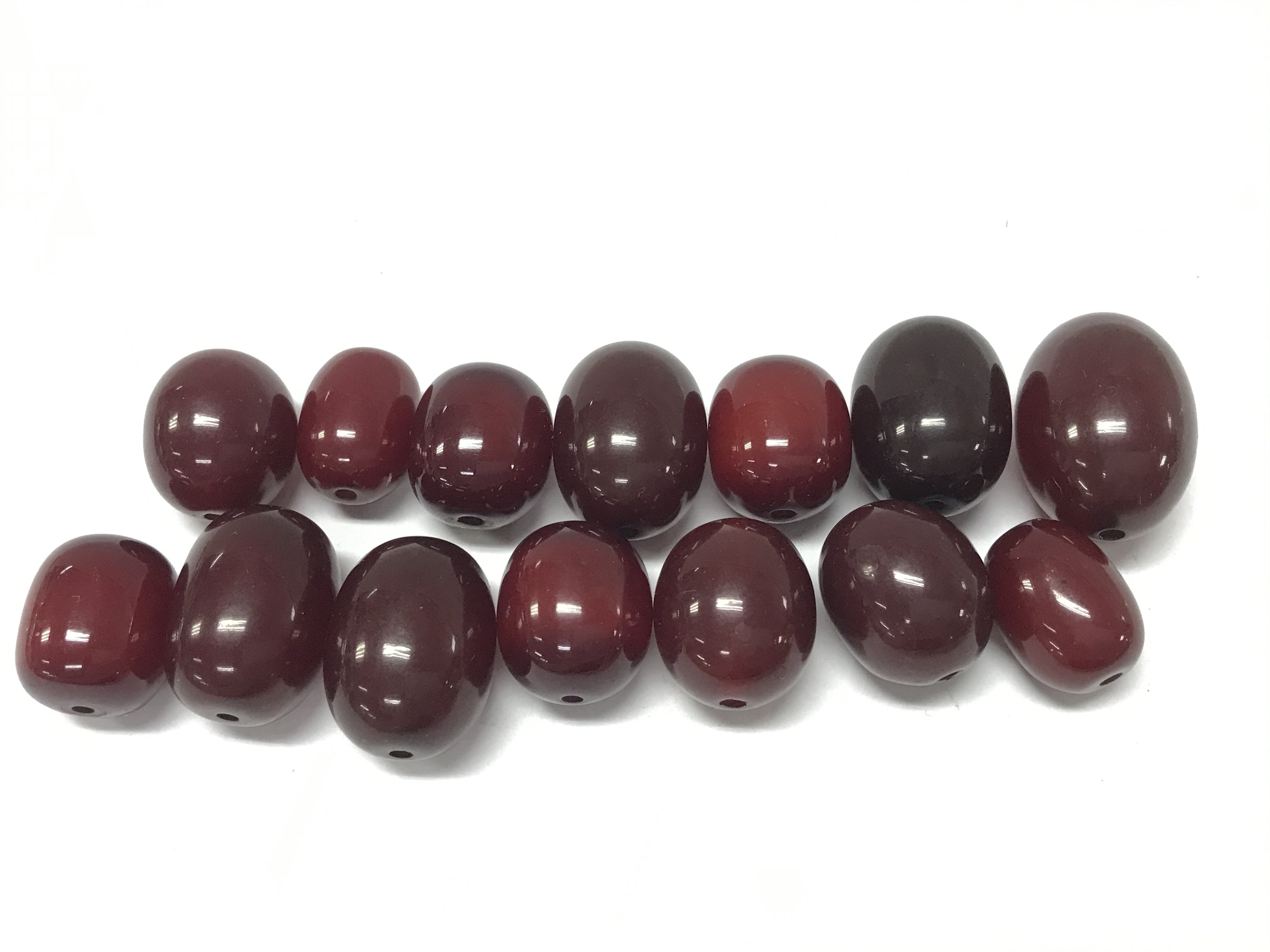 Cherry amber colour Bakelite style 14 large necklace beads , largest bead 29mmx21mm , total weight 80g. Postage category A