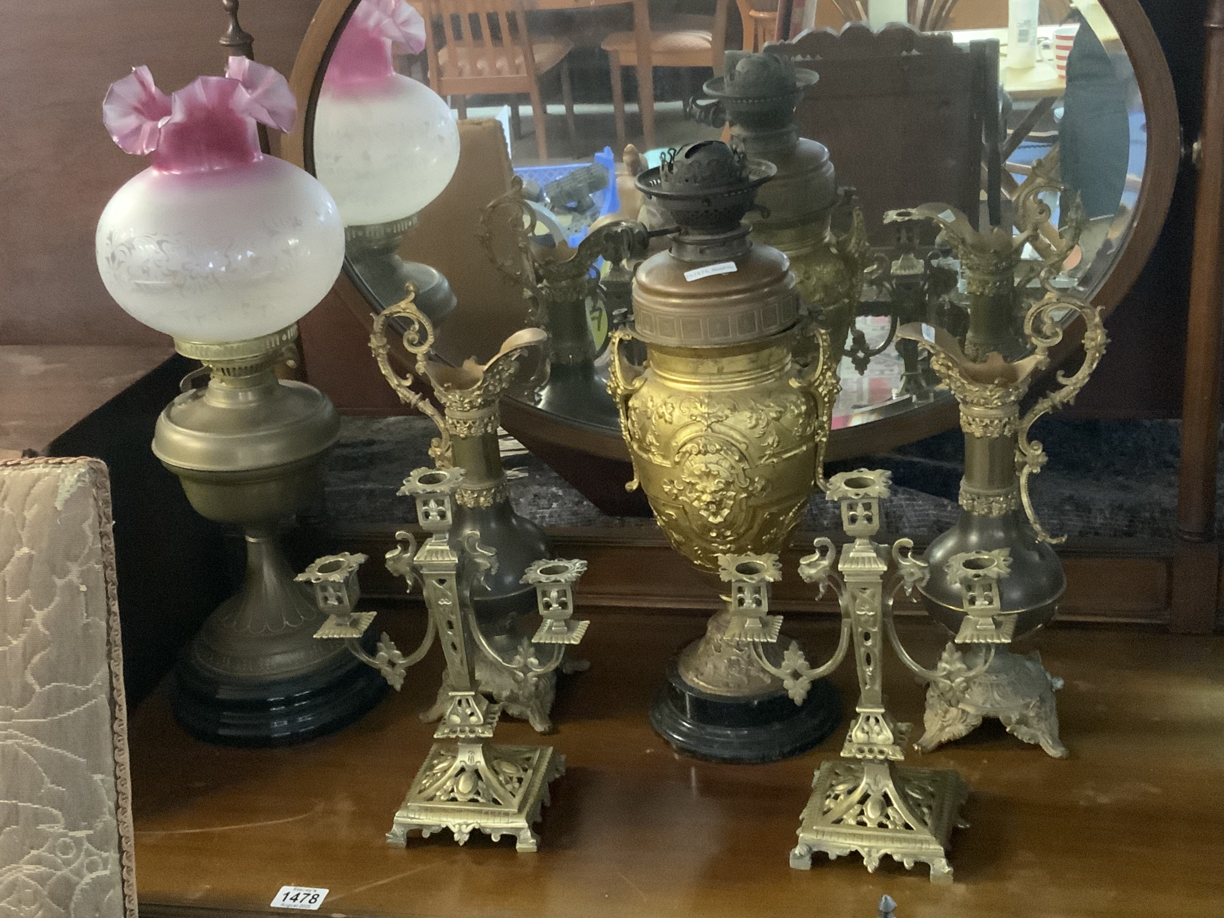 A gilt metal mounted oil lamp base, a pair of brass candelabra, Evers, Victorian oil lamp with etched shade.