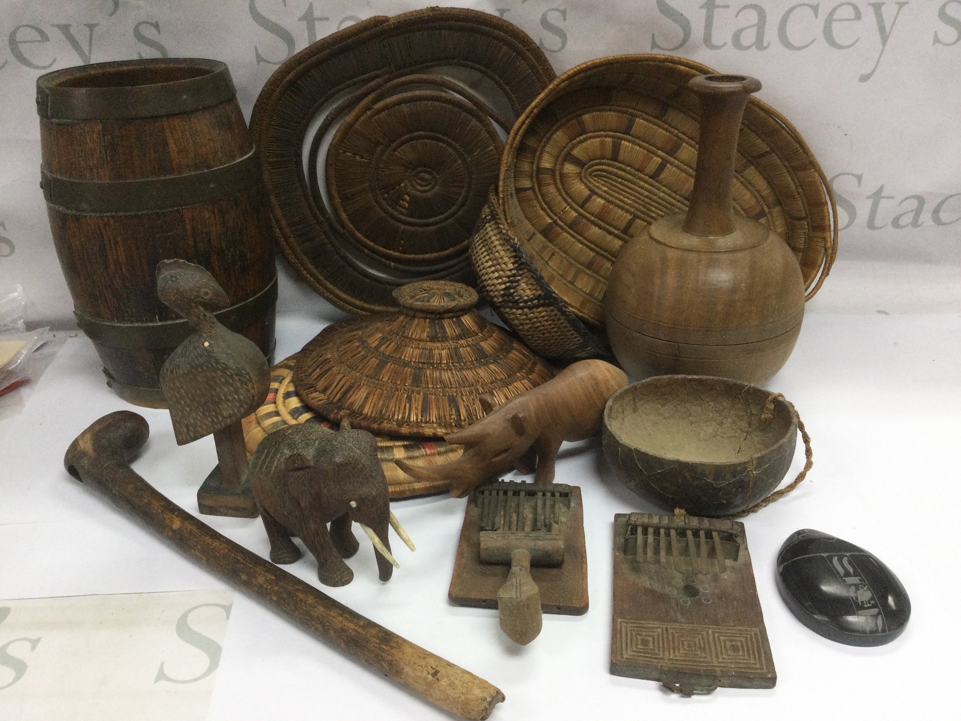 A collection of tribal baskets, carved ornaments, elephant whip etc. Shipping category D.