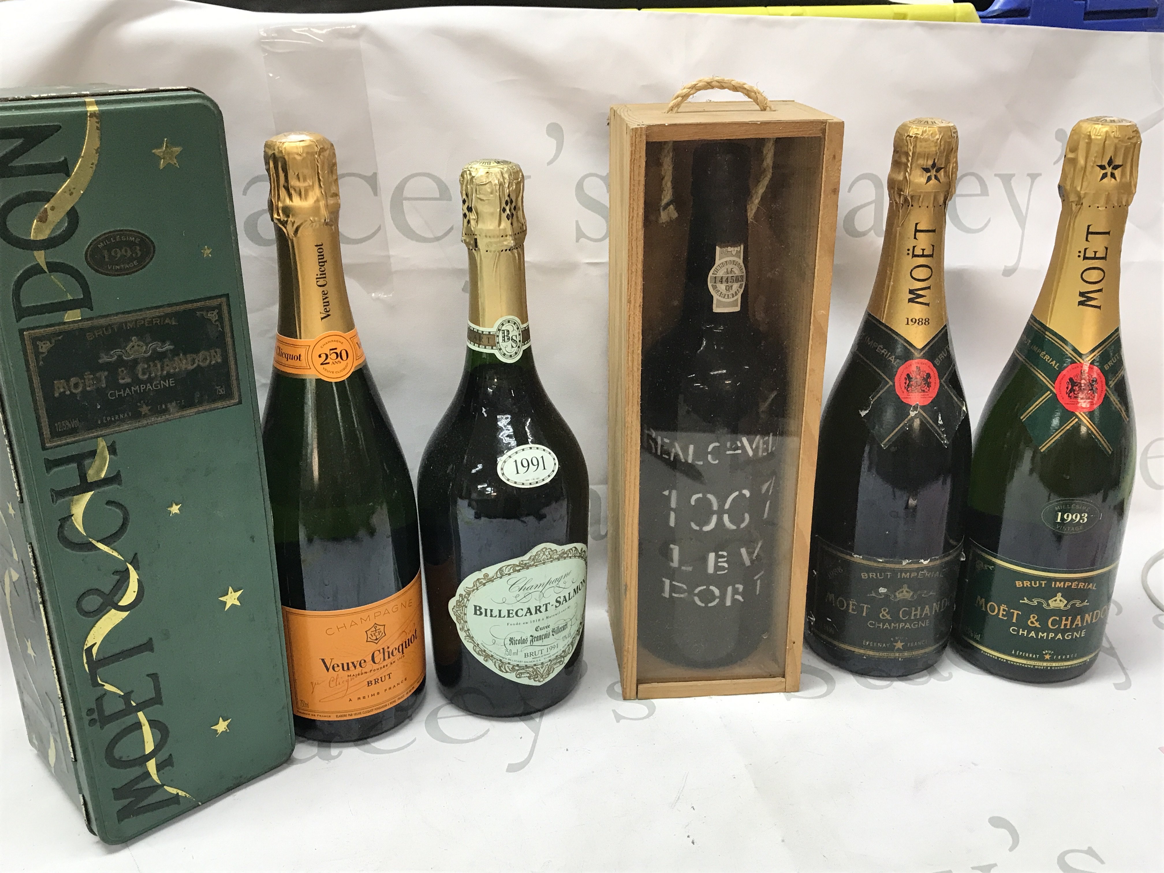 A collection of champagne including Moet & Chandon, Royal Oporto 1967 port, 1991 Billecart Salmon, Veuve Clicquot champagne . This lot cannot be posted