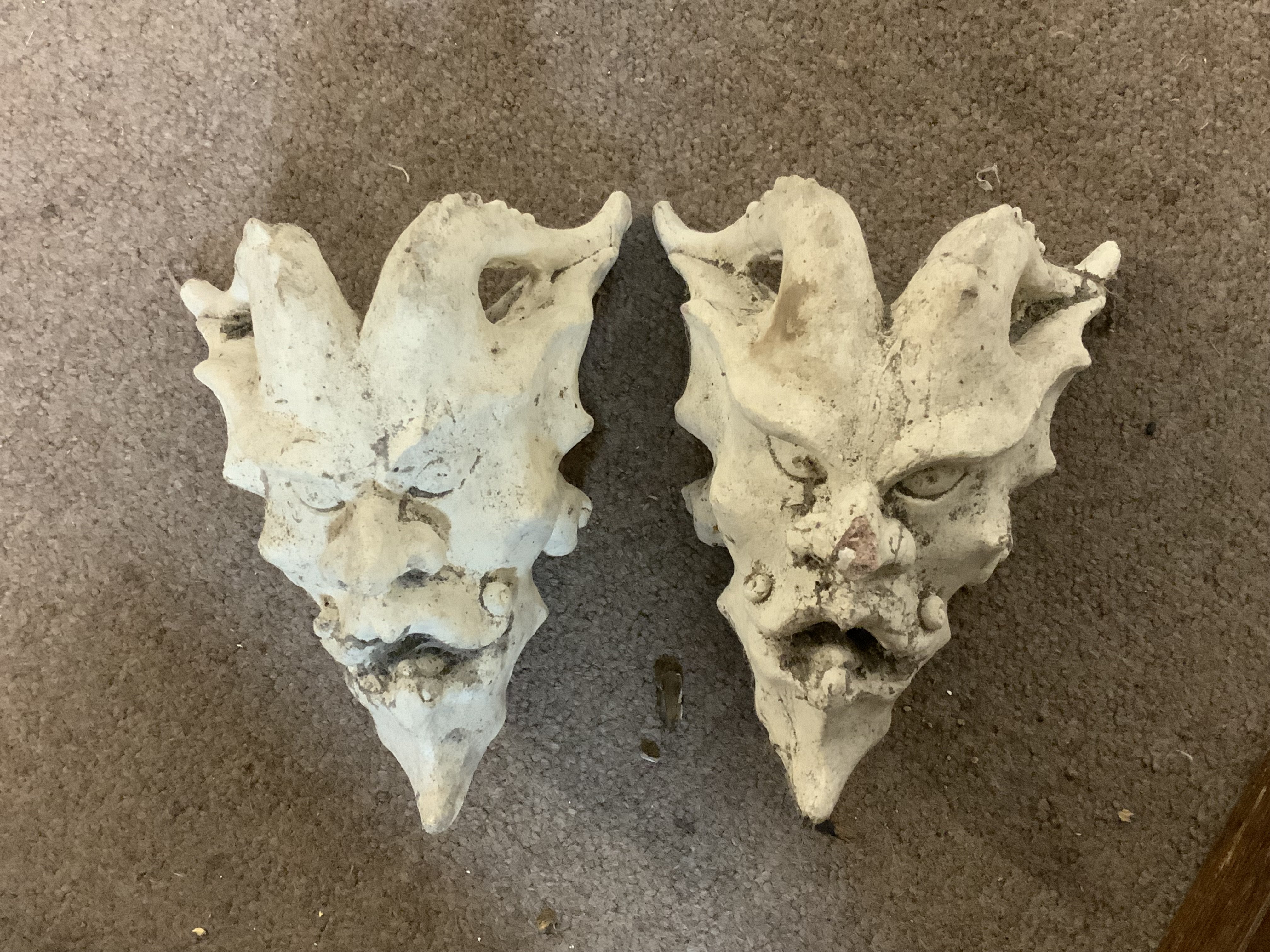 A pair of plaster Devil wall masks