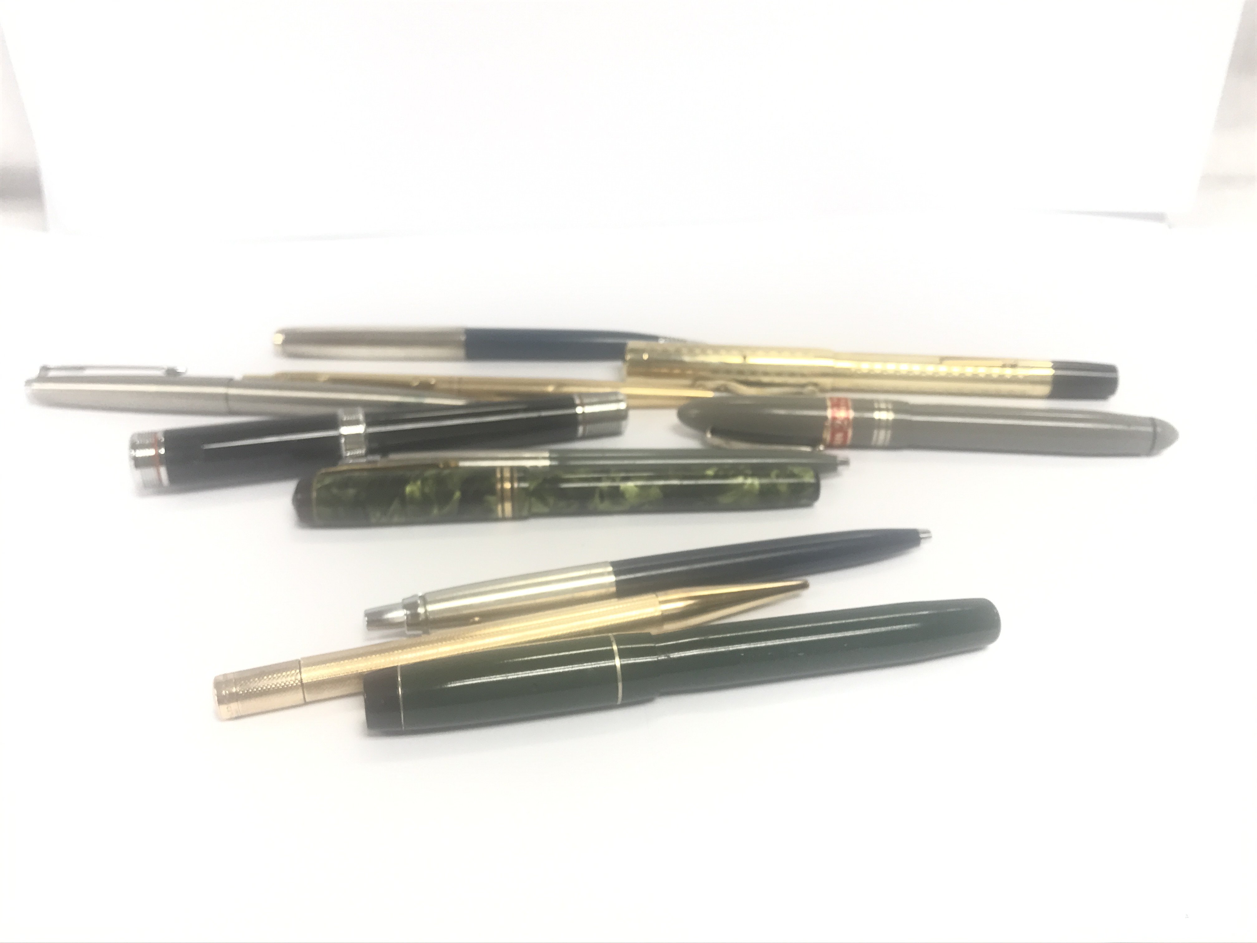 A collection of vintage fountain pens and pencils including Parker, Swan, Conway Stewart, Rolled Gold Pencil