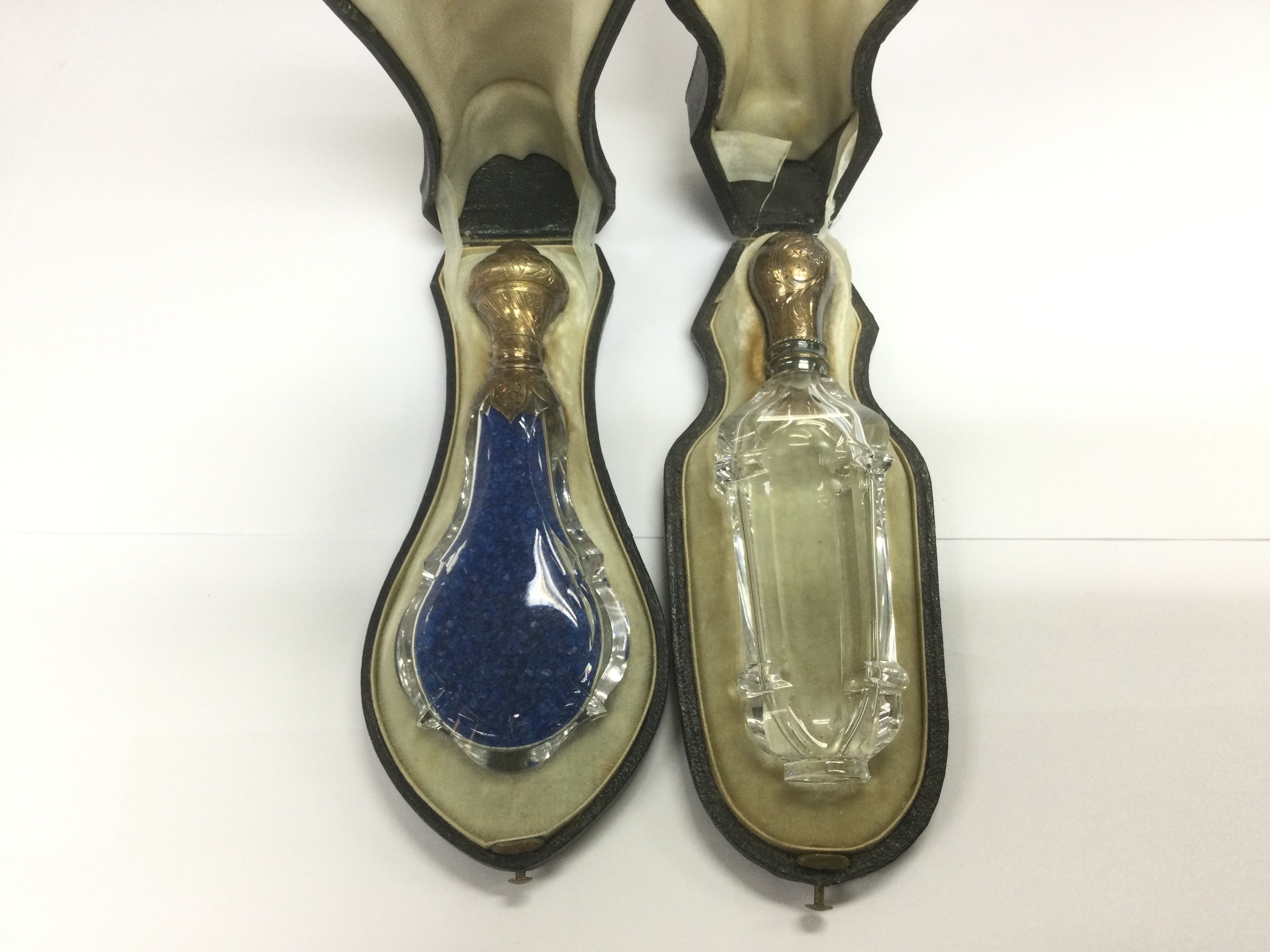 Two Victorian leather cased glass scent bottles. Shipping category D.