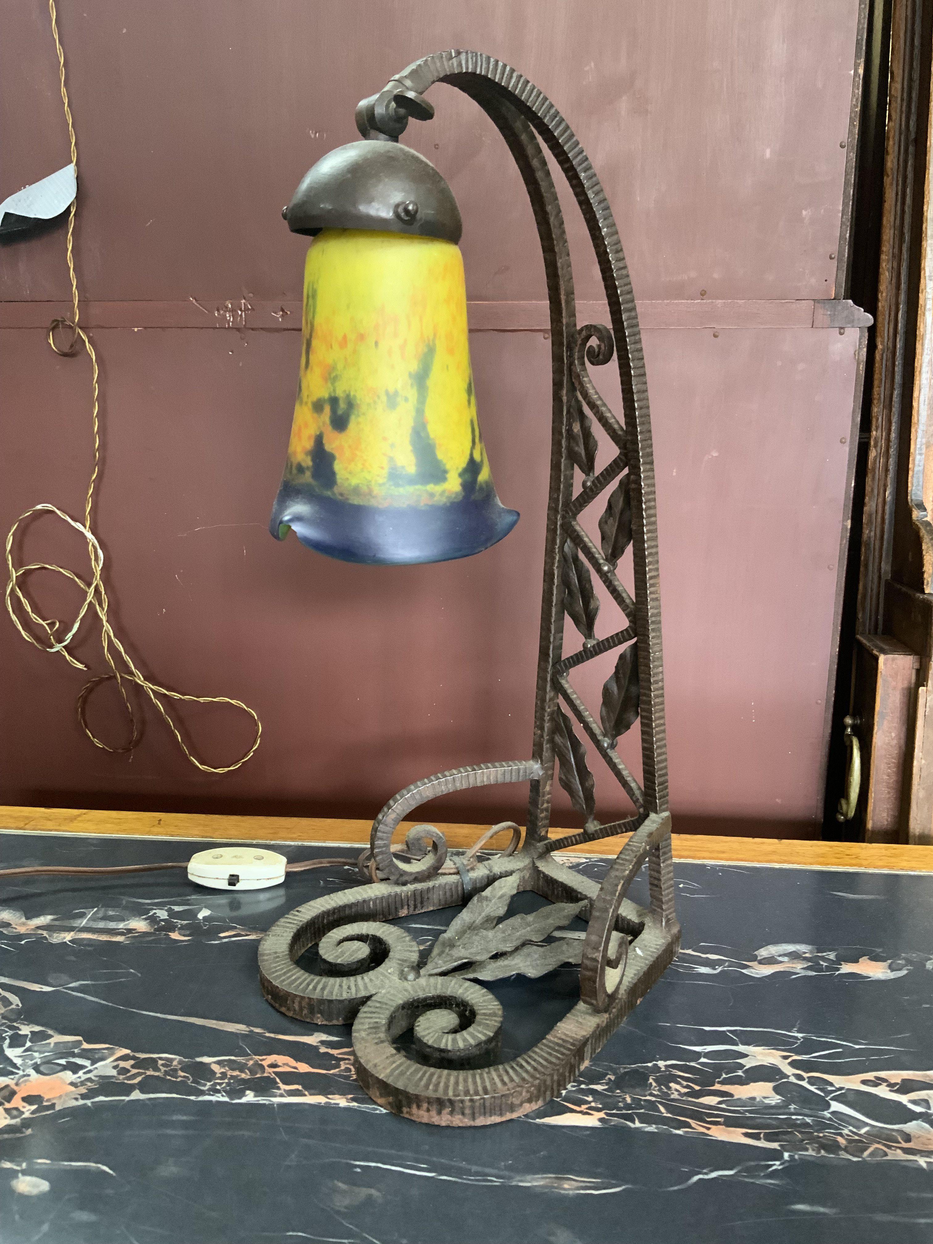 A French art deco wrought iron table lamp with pate de vere tulip glass shade.