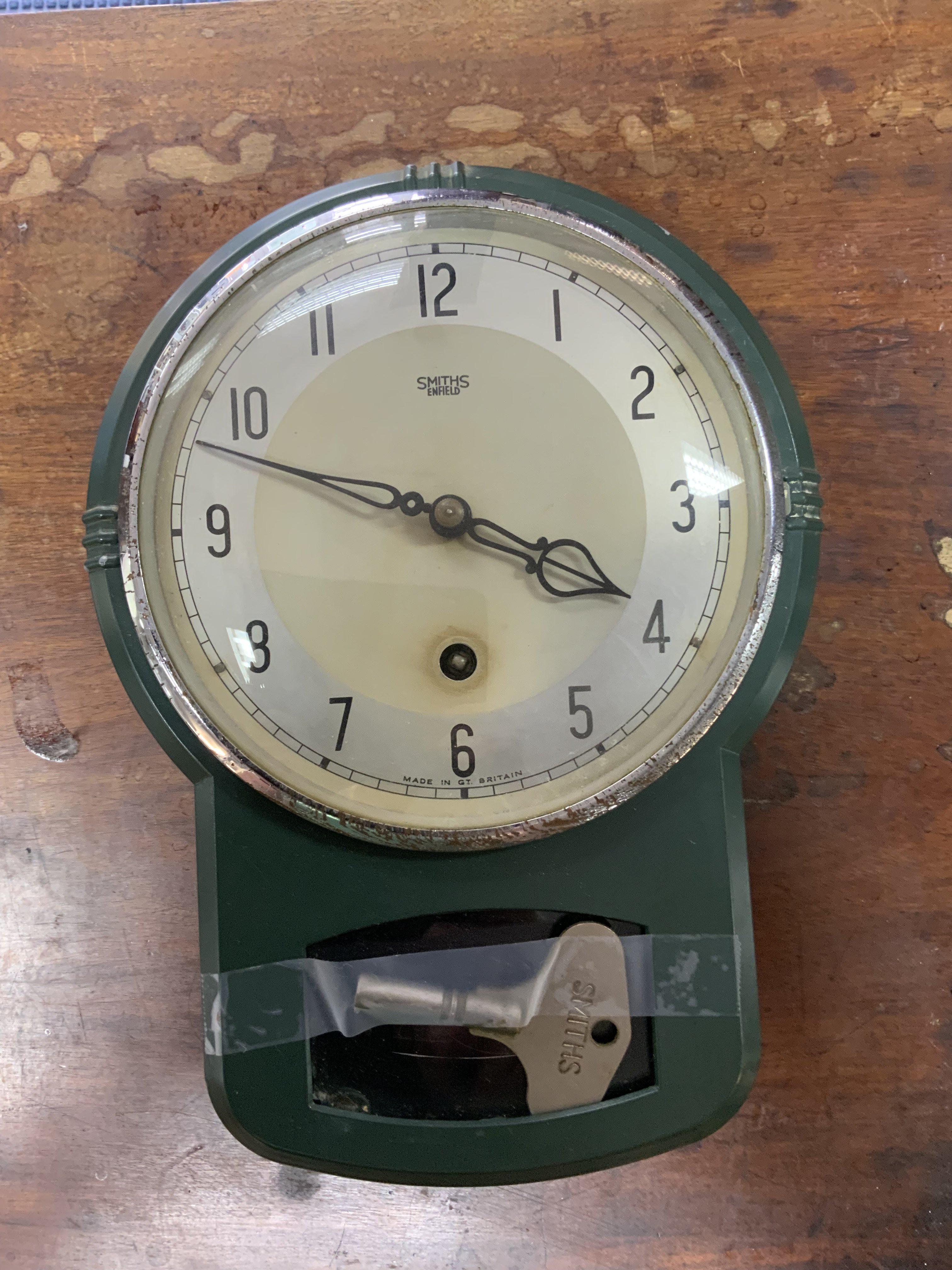 A Vintage 1950s green enamelled metal smiths wall clock, 26cm.