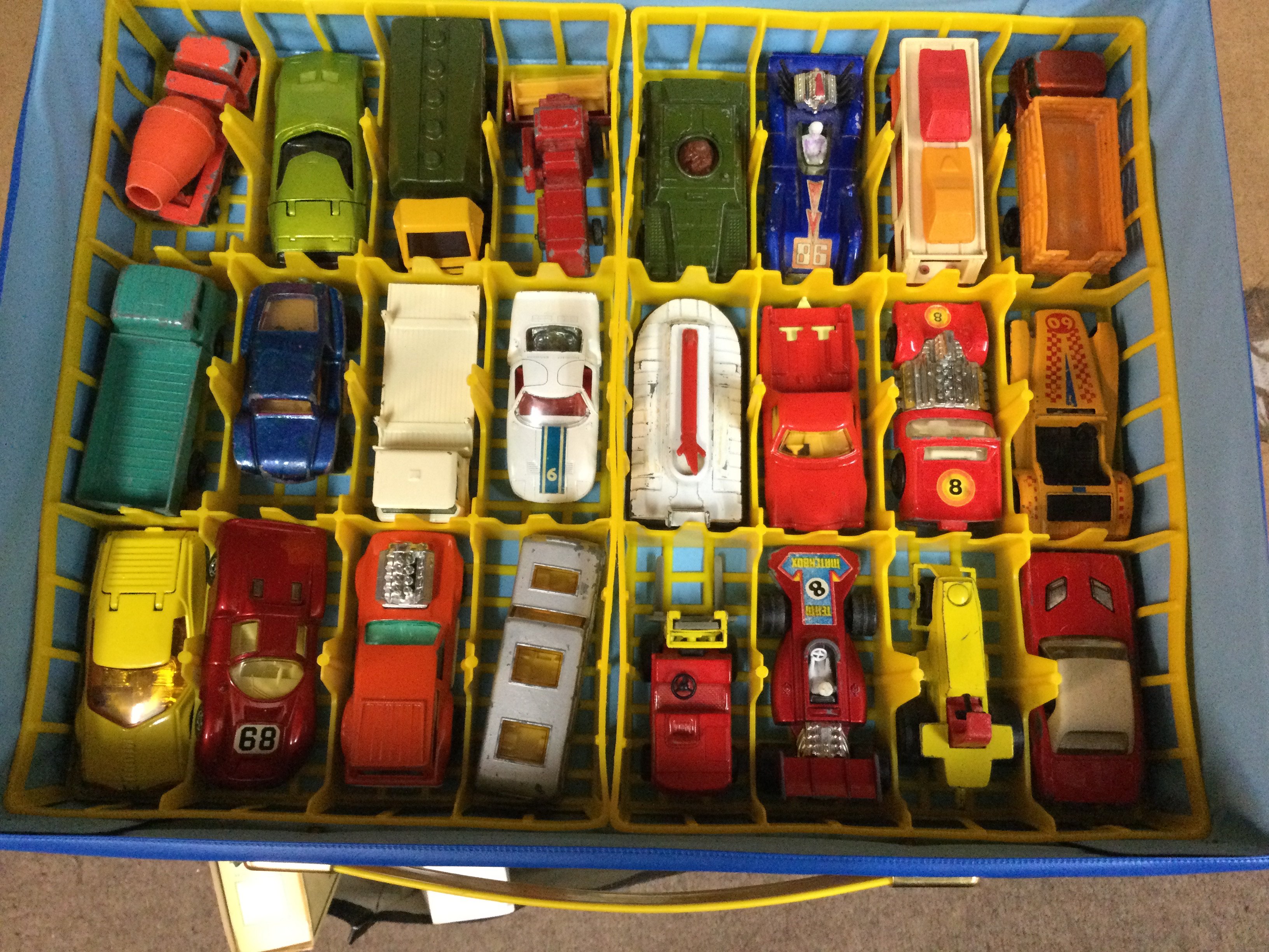 Matchbox carrying case containing various model cars .