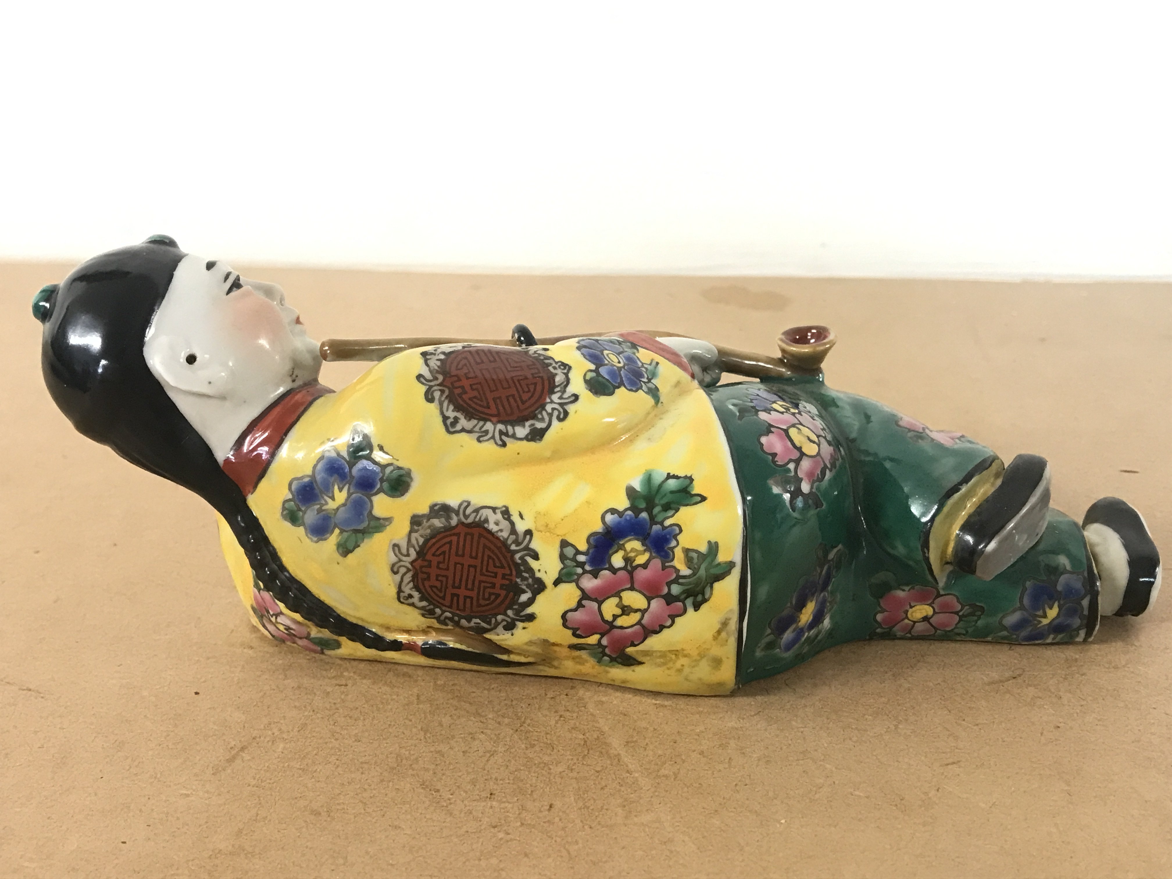 A Chinese Opium smoker porcelain figure 7.5cm tall 19.5cm long. Four character mark to base. This lot cannot be posted- NO RESERVE