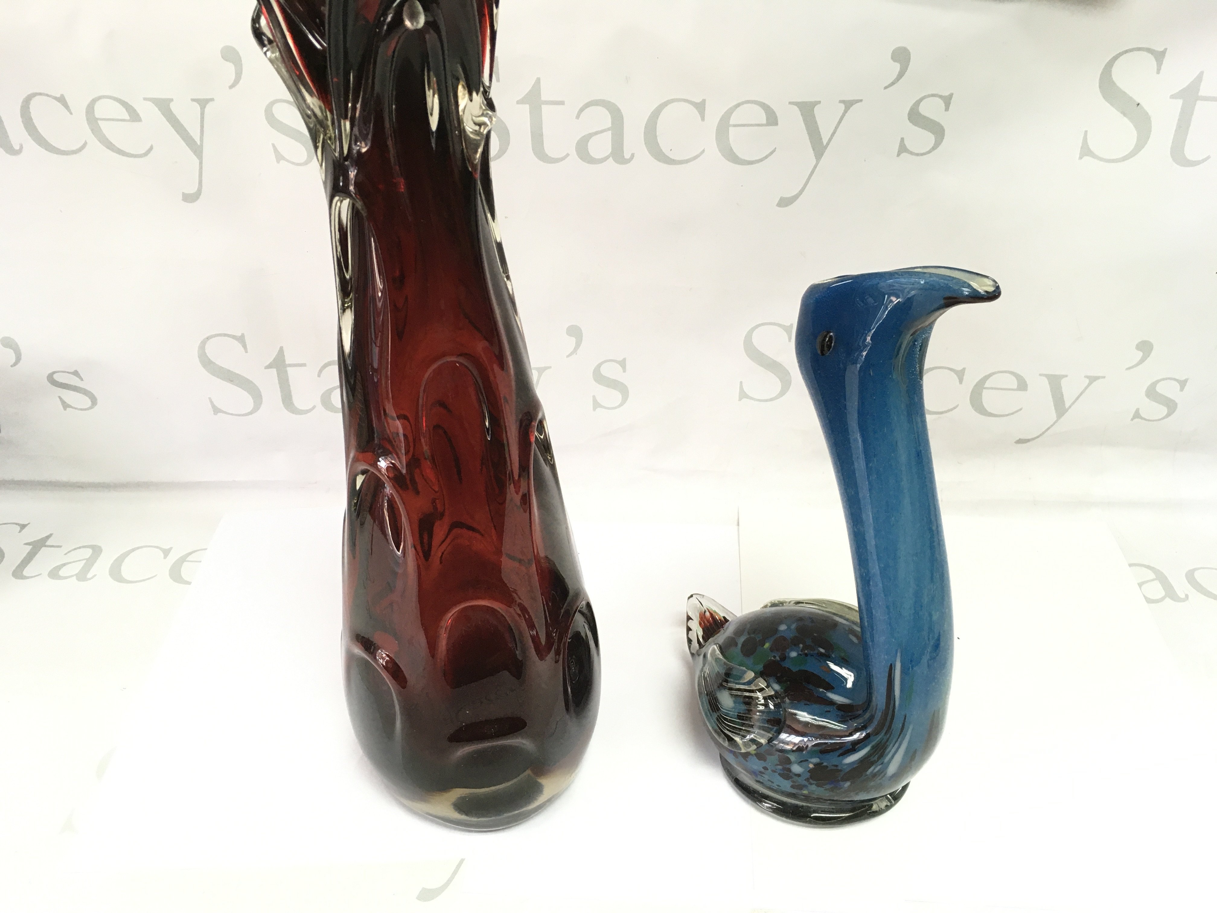 A Murano style glass vase and a tall red glass vase.