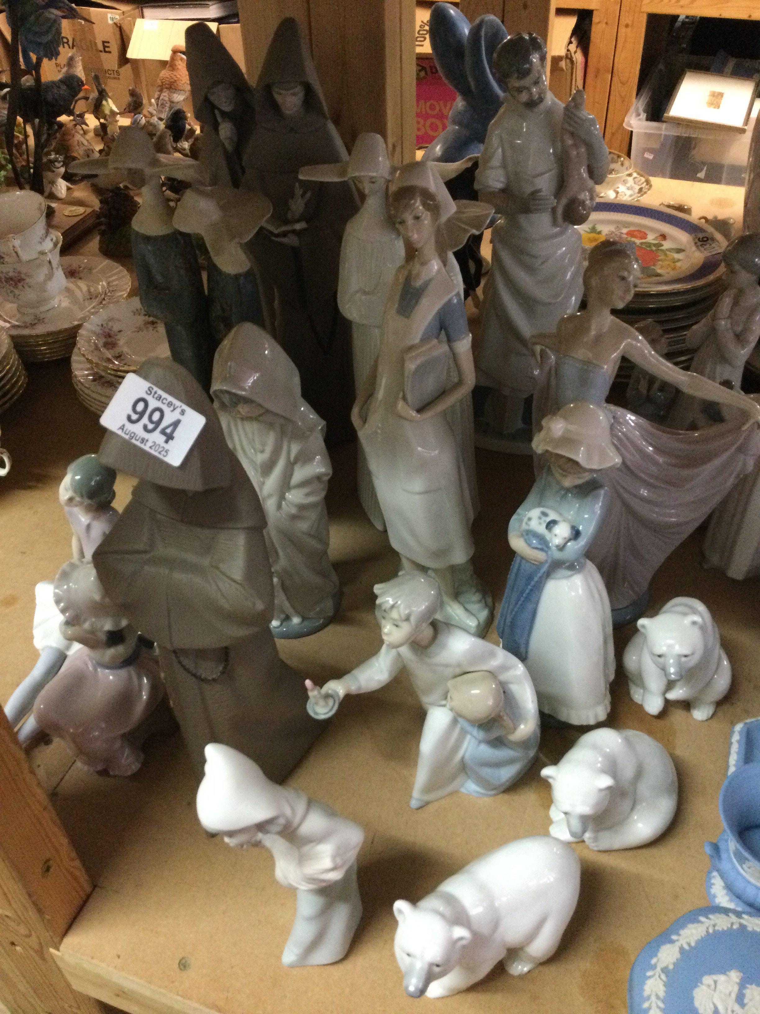 A collection of 16 Lladro figures including dancing figures polar bears.