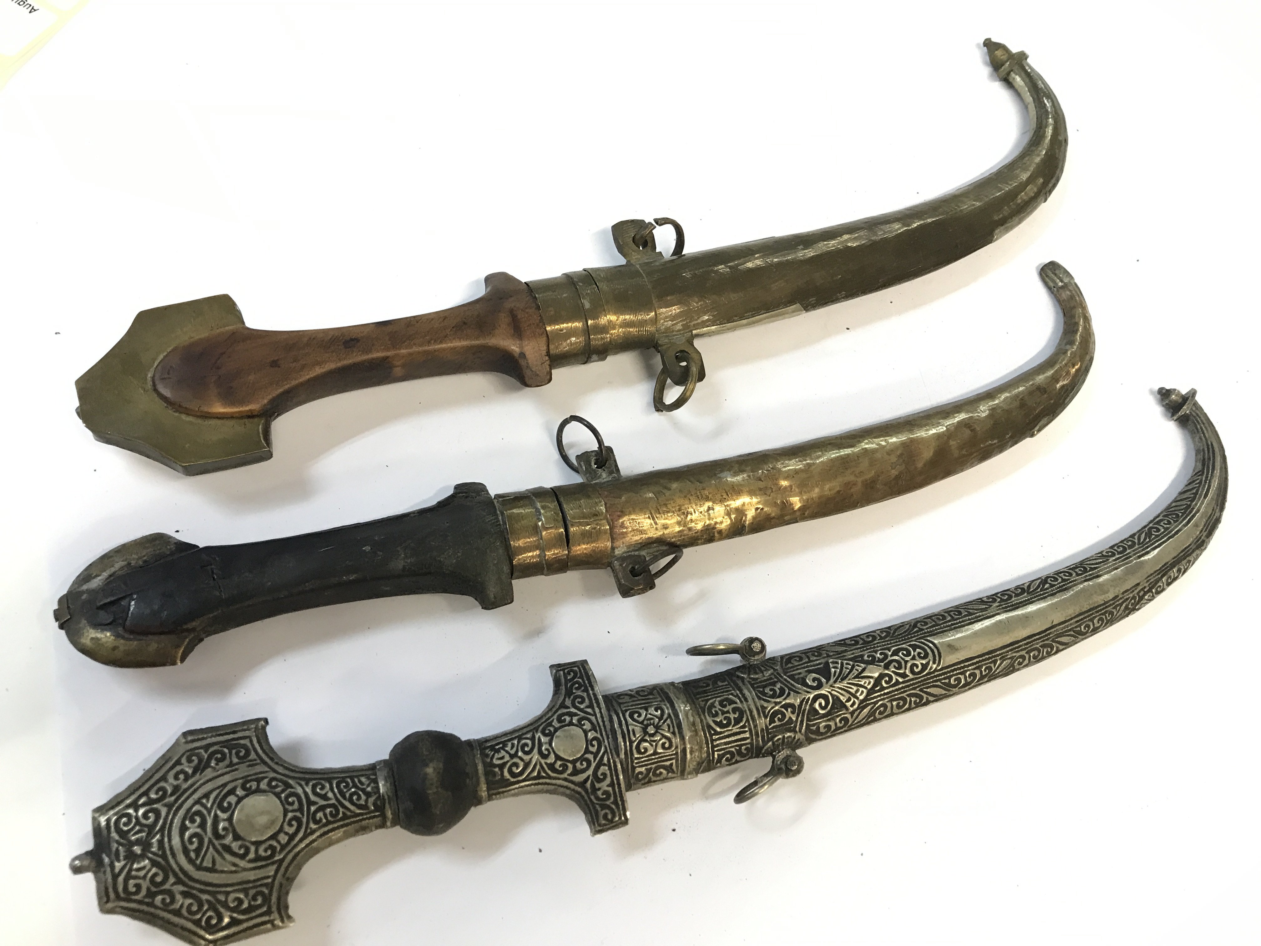 Three Moroccan Trina Koummya Daggers with brass and silvered scabbards (3)
