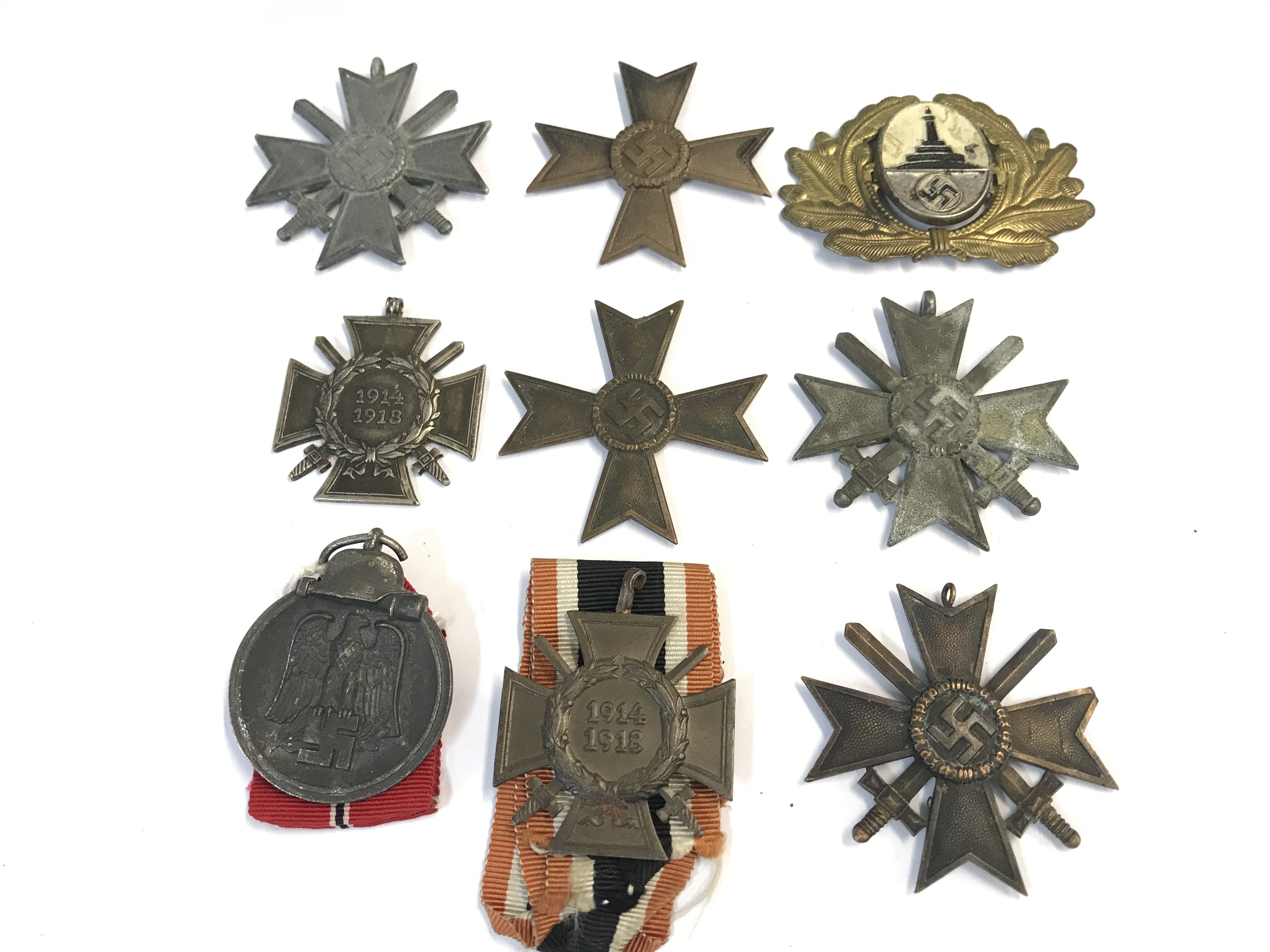 A collection of German II world war medals including a long service good conduct iron cross, a Russian Eastern Europe battle medal a rare Veterans cap badge and others.