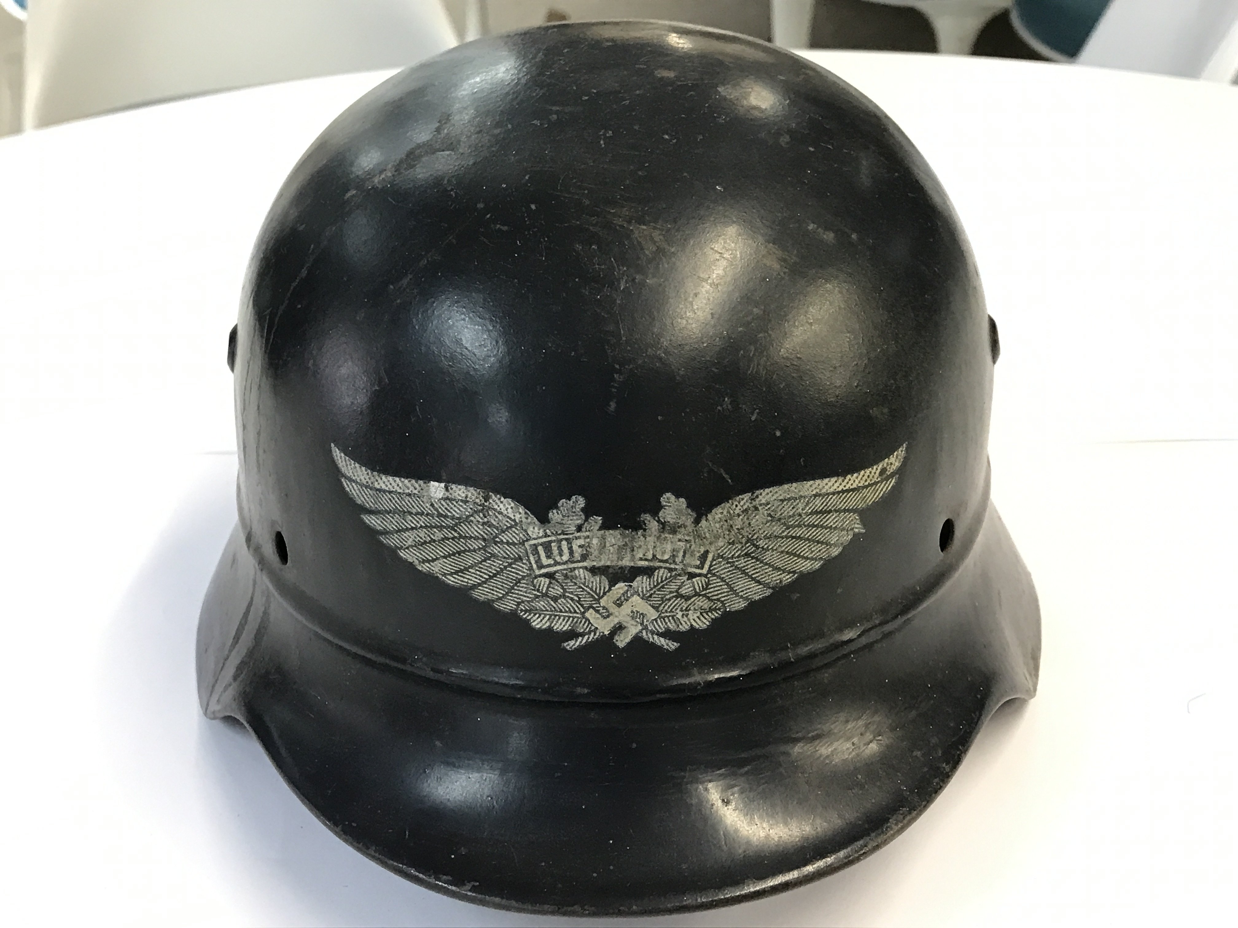 A German Third Reich Luftschutz fire helmet with no lining. With stamped EF64 and 675.