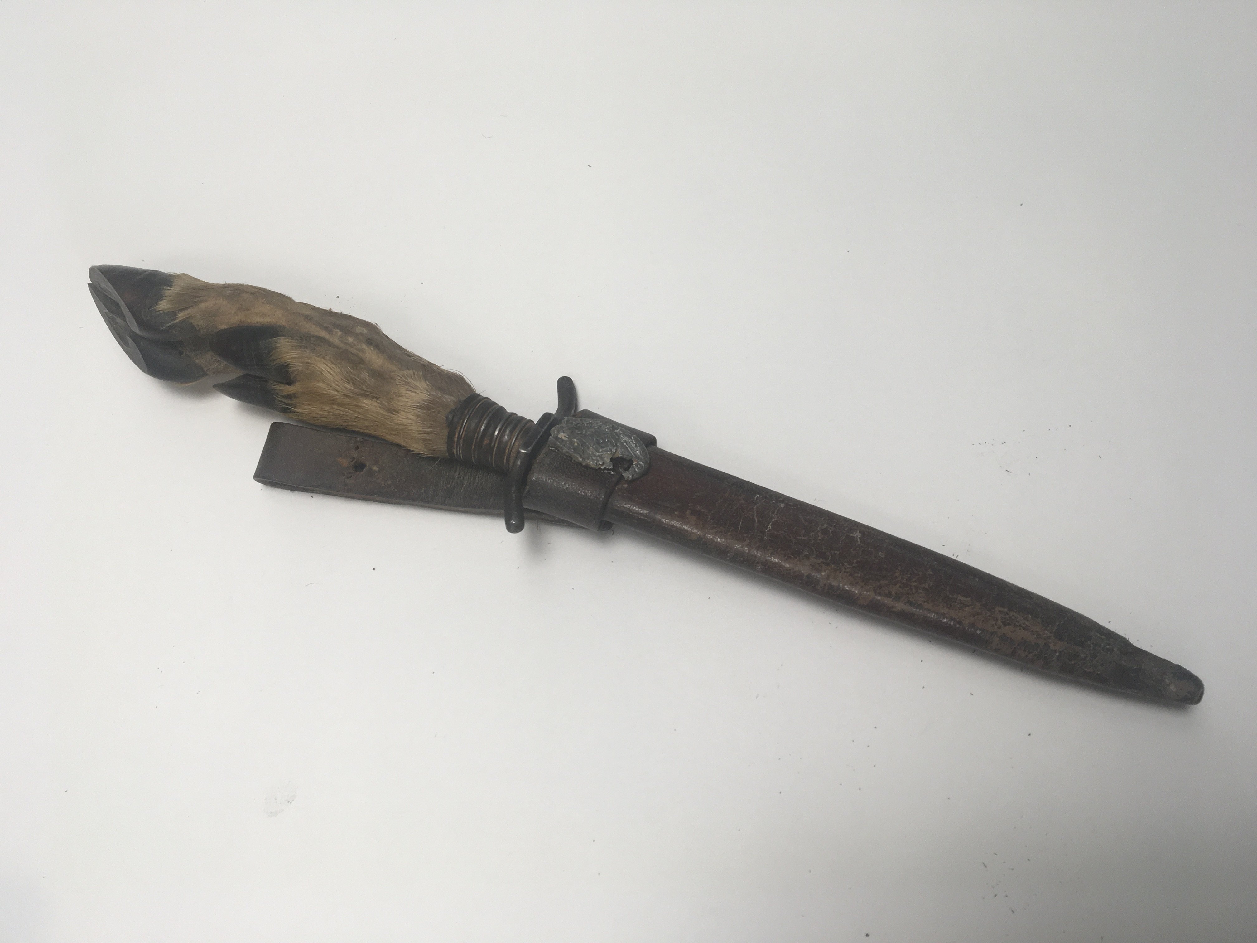 A German Fighting knife possible I world war Imperial. With a deer hoof handle the leather scabbard with applied additional Third Reich badge 1936.