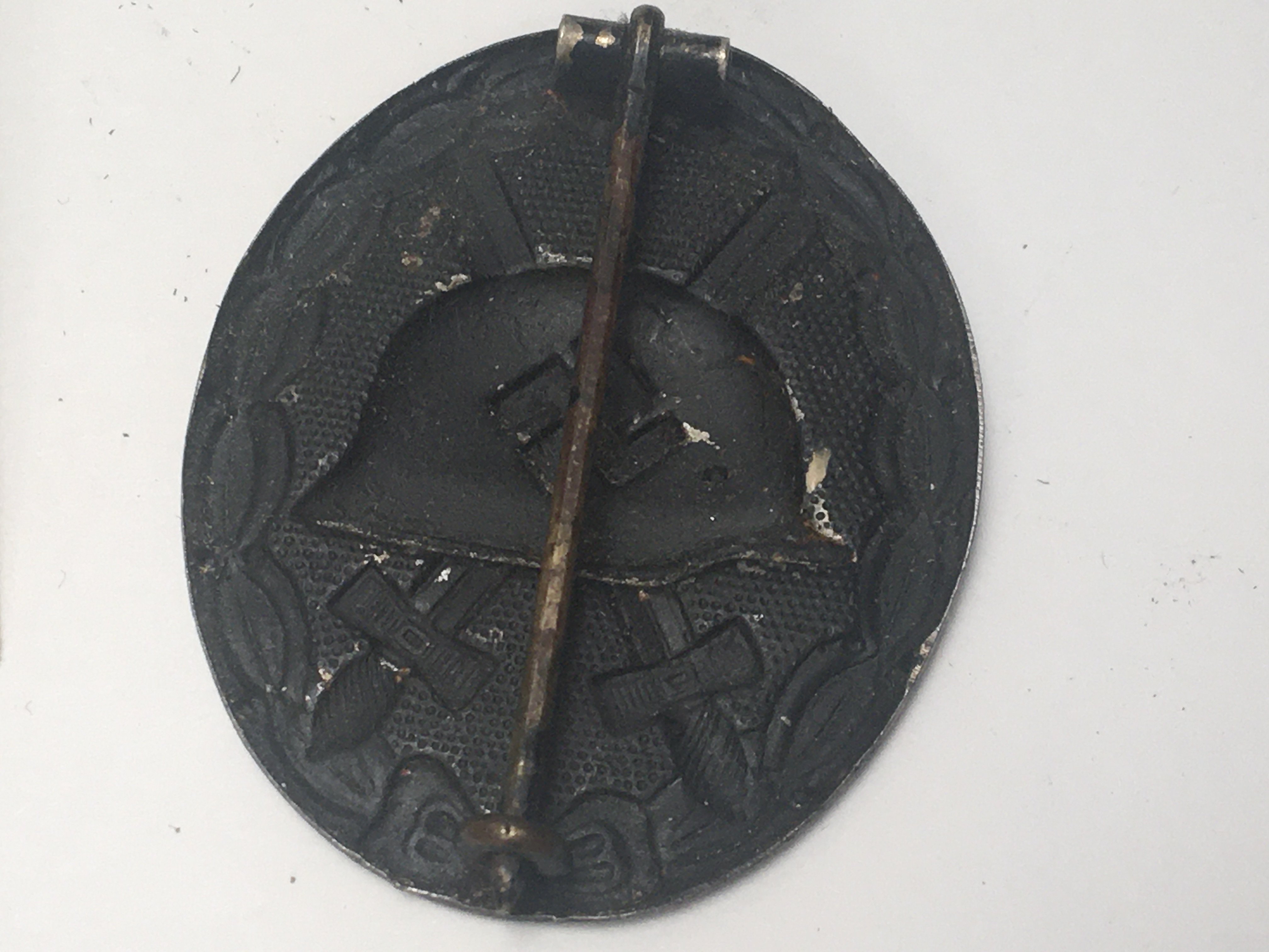 A German Third Reich Wound badge with medal ribbon and photograph of the recipient the reverse of the photo with hand written inscription 1943.