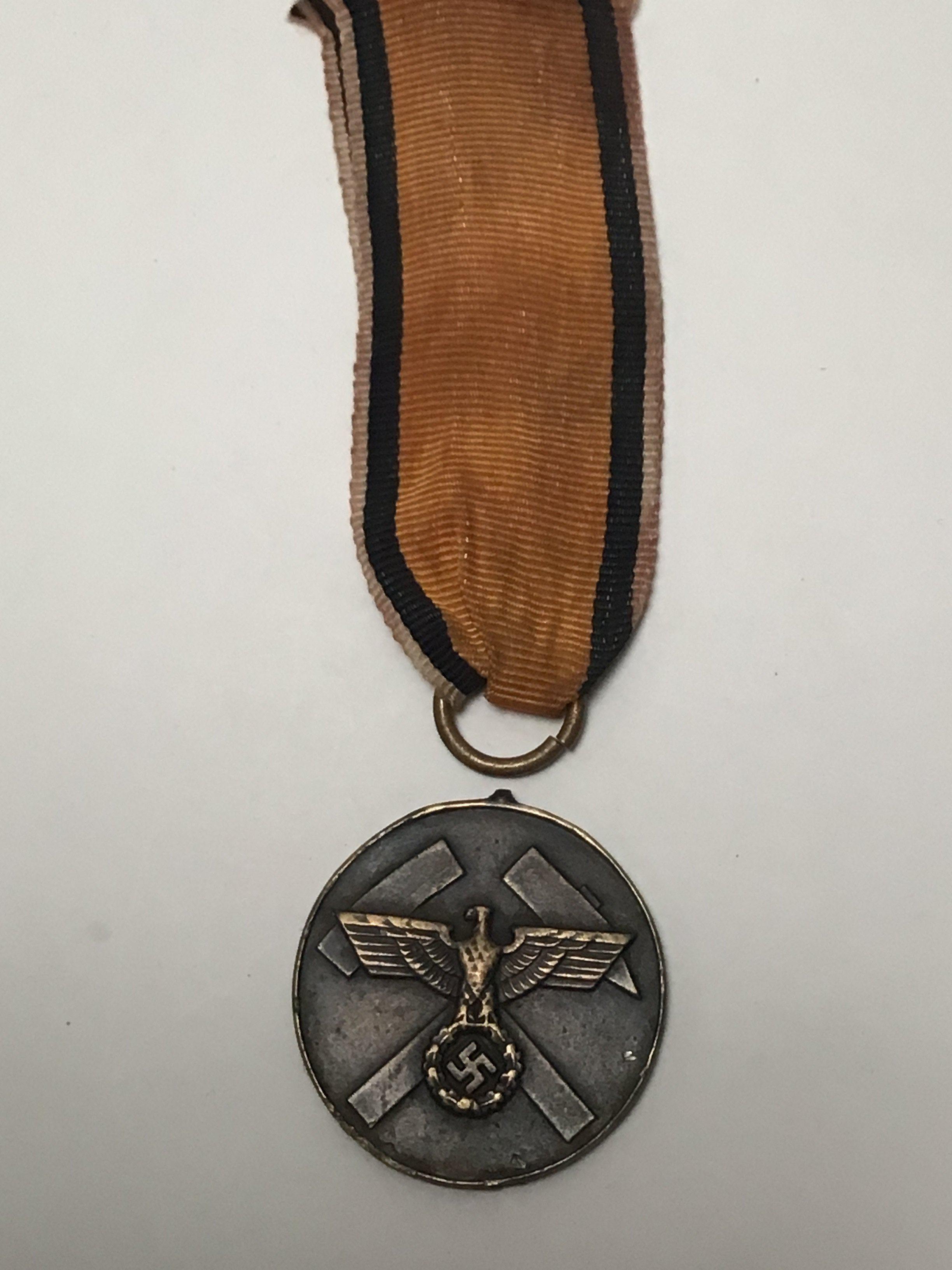A rare German Third Reich Mine Rescue Medal with ribbon detached top ring.